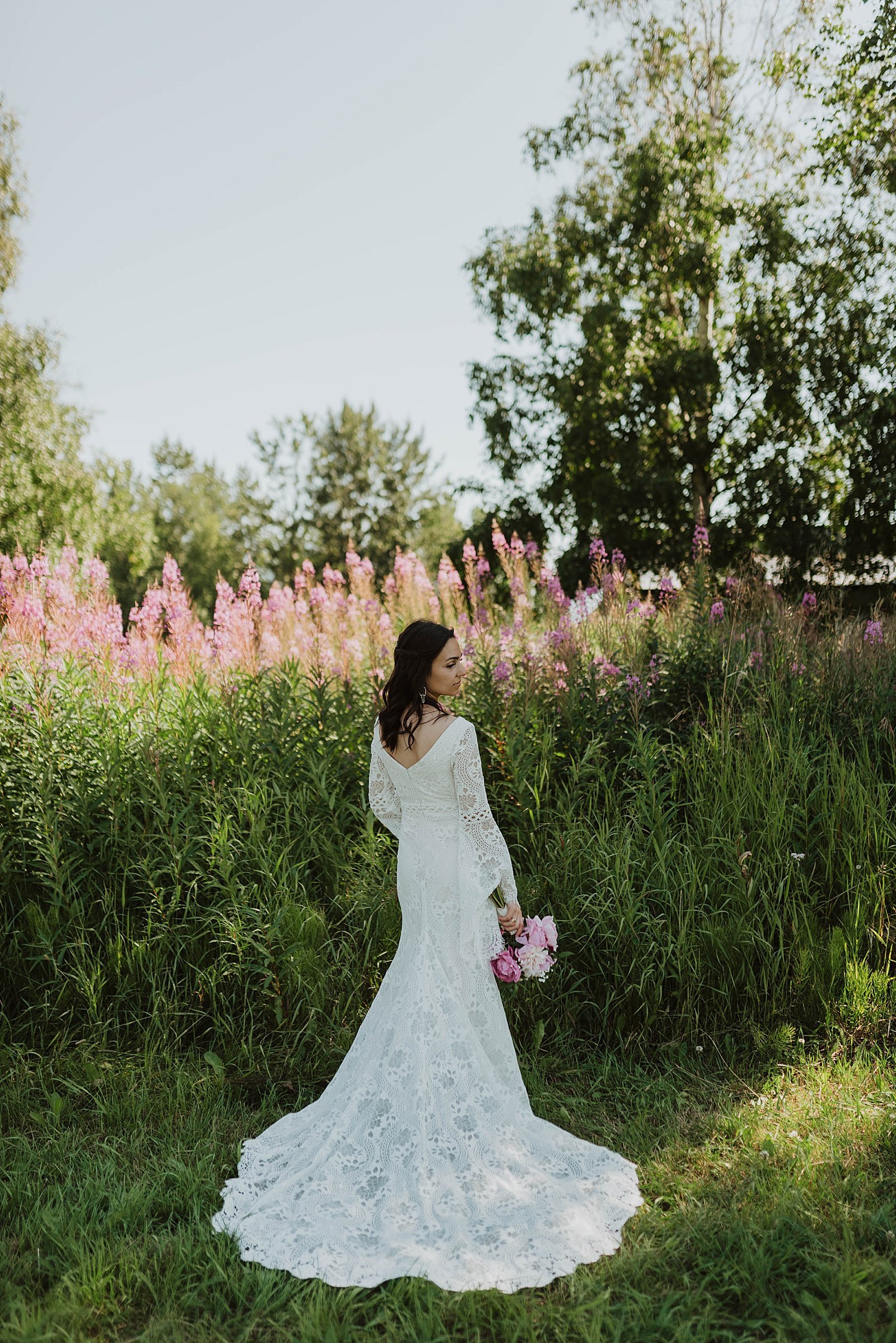  Bride standing in front of a big field in Alaska  