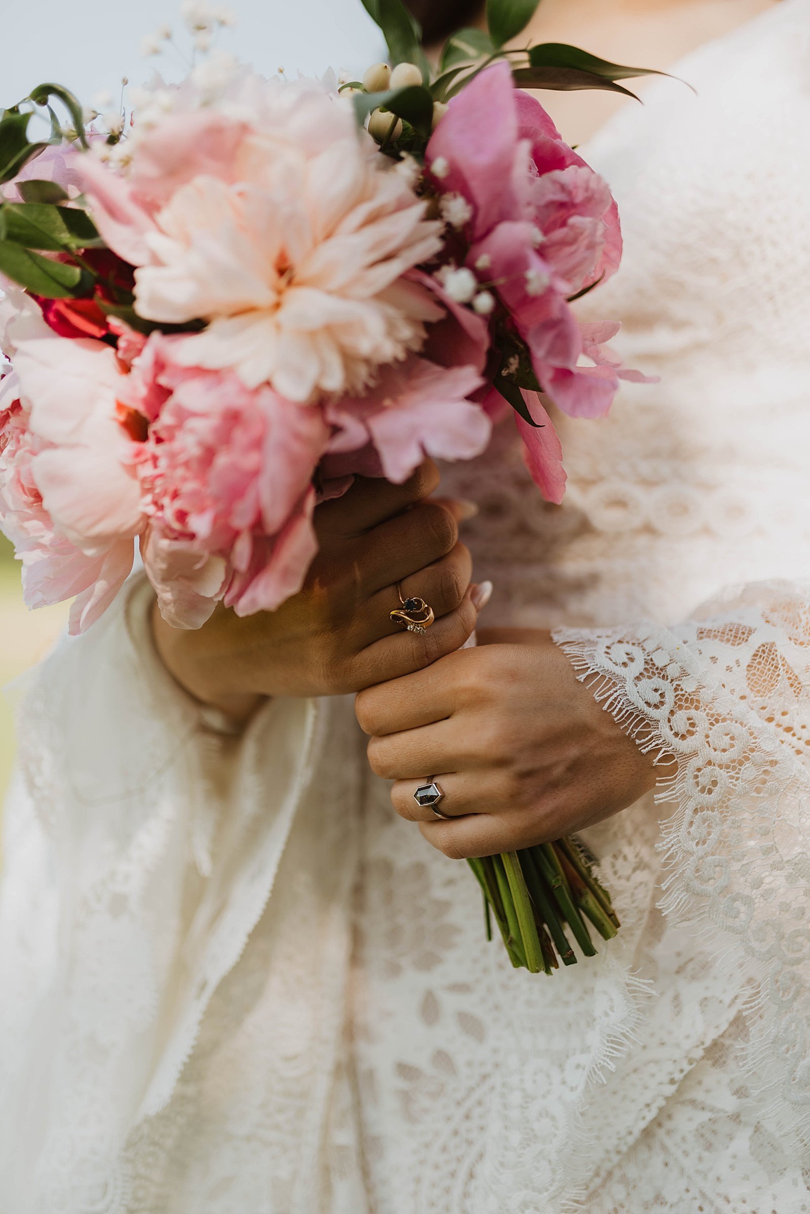  Bride holding flowers with her new wedding band on her finger by Alaska wedding photographer, Theresa McDonald.  