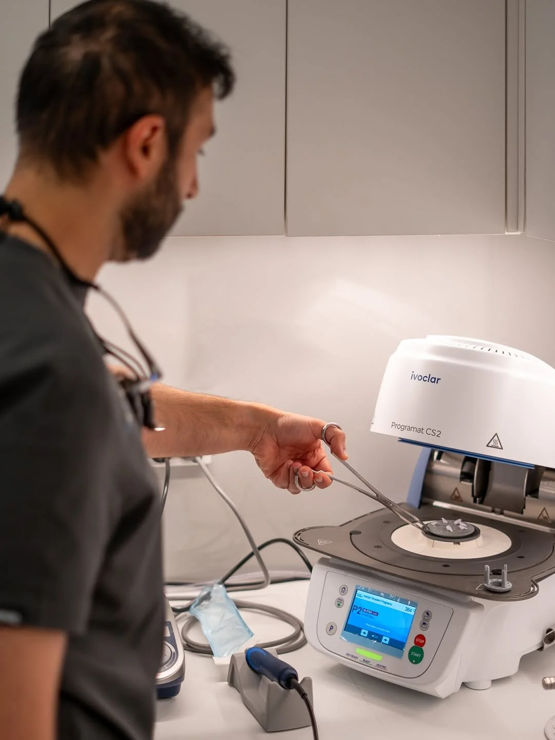 Dr Mustafa Bassam preparing veneers on the furnace machine