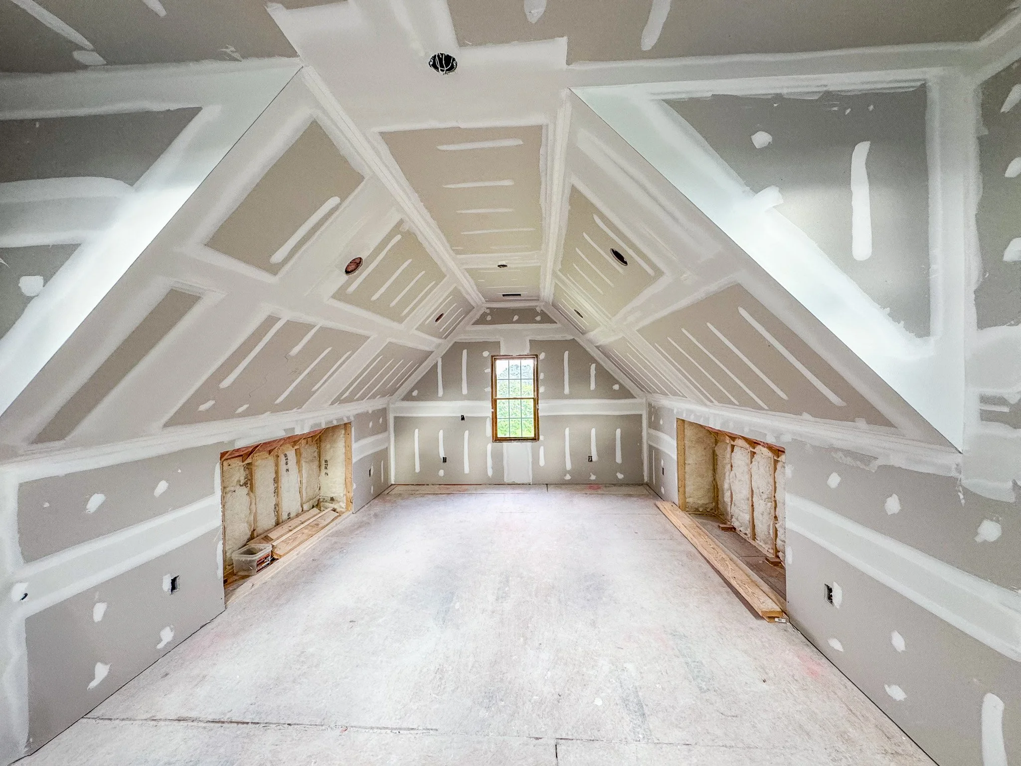 Attic build-out with insulation installation and framing in progress during renovation in Fuquay-Varina NC