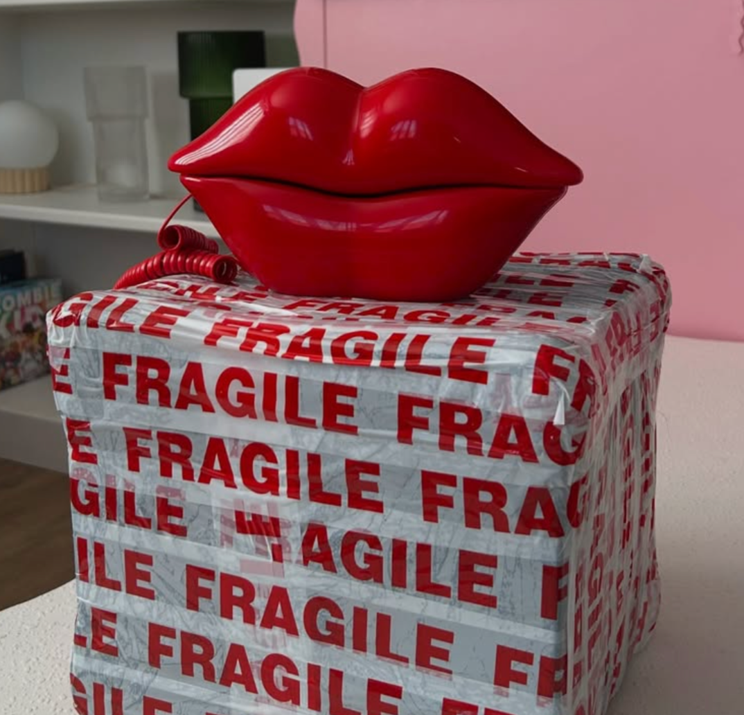 A red audio guest book phone in the shape of lips