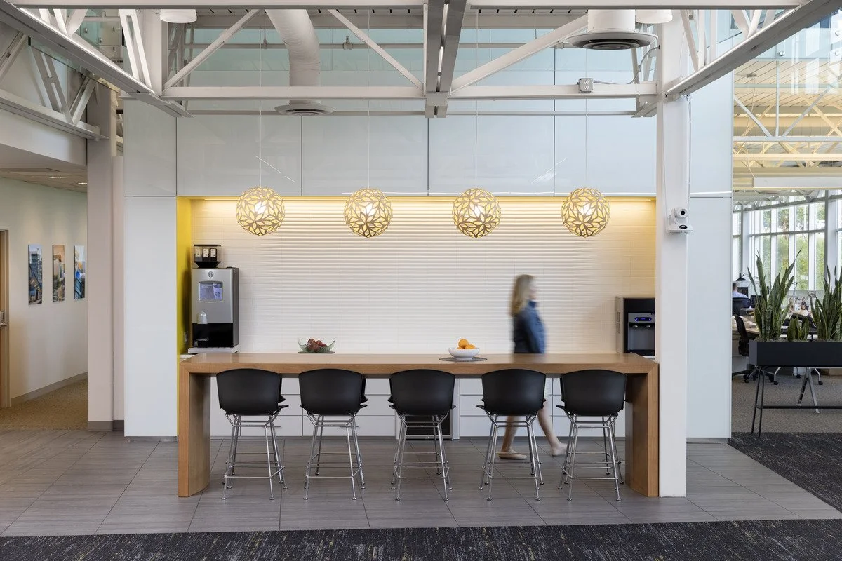 Pivotal remodeled Flad’s lobby, highlighting architectural cove and slot details, interior pendant lighting, accent illumination, grazing light effects, and uplighting. 