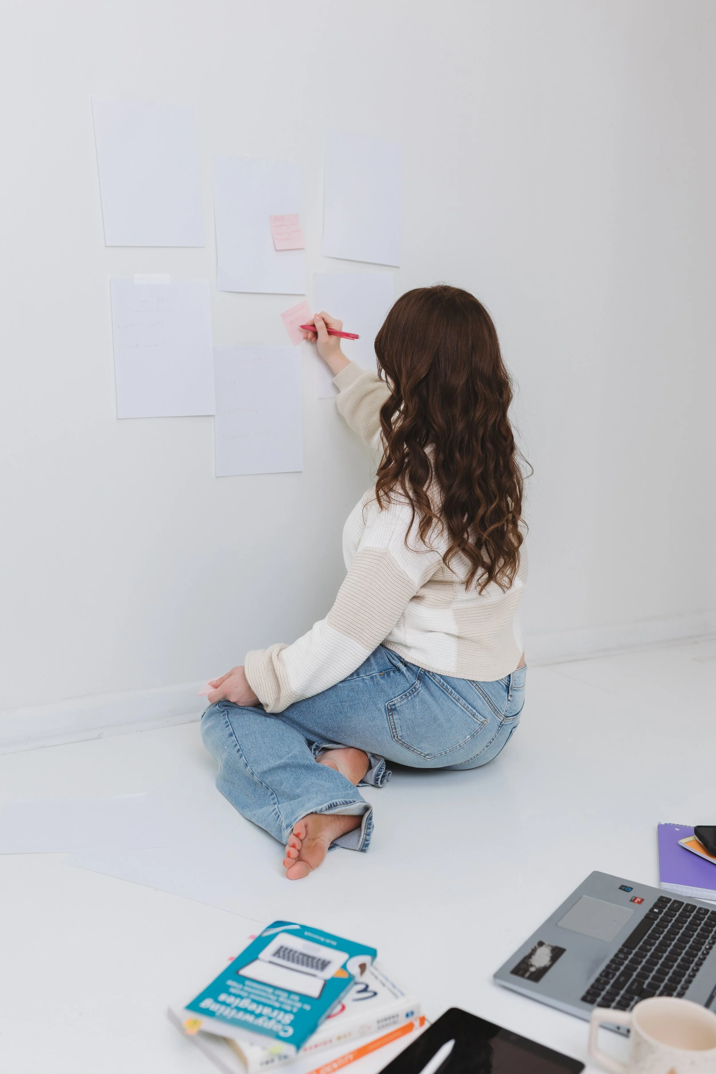 Evergreen marketing specialist Amanda the Assistant writes notes in a photo studio.