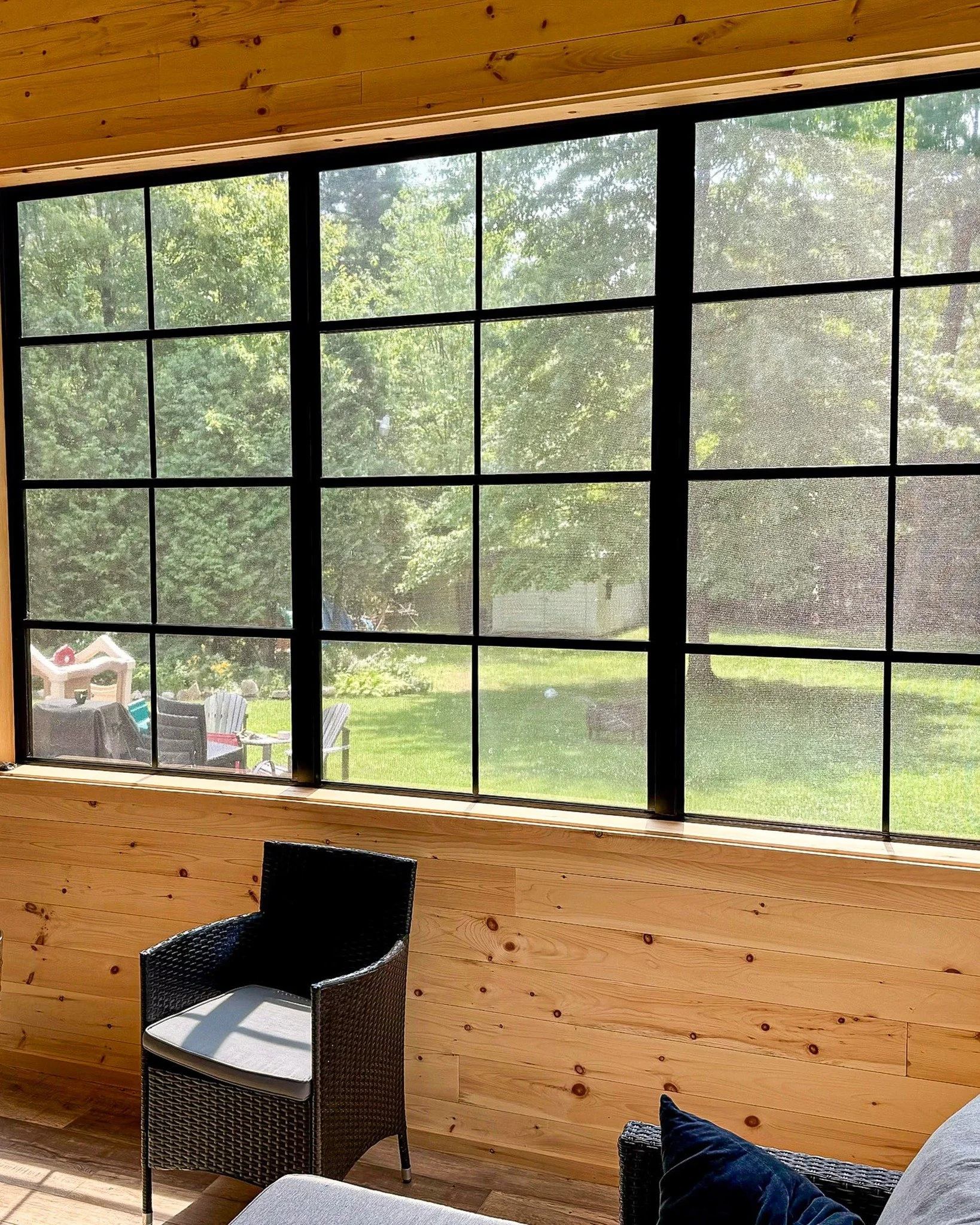 A full window wall designed to maximize natural light while maintaining a strong, structured look.

Black framing contrasts with warm wood finishes, creating a balanced and inviting space.

Built in Ile-Perrot.

#montrealhomes #westislandmontreal #mt