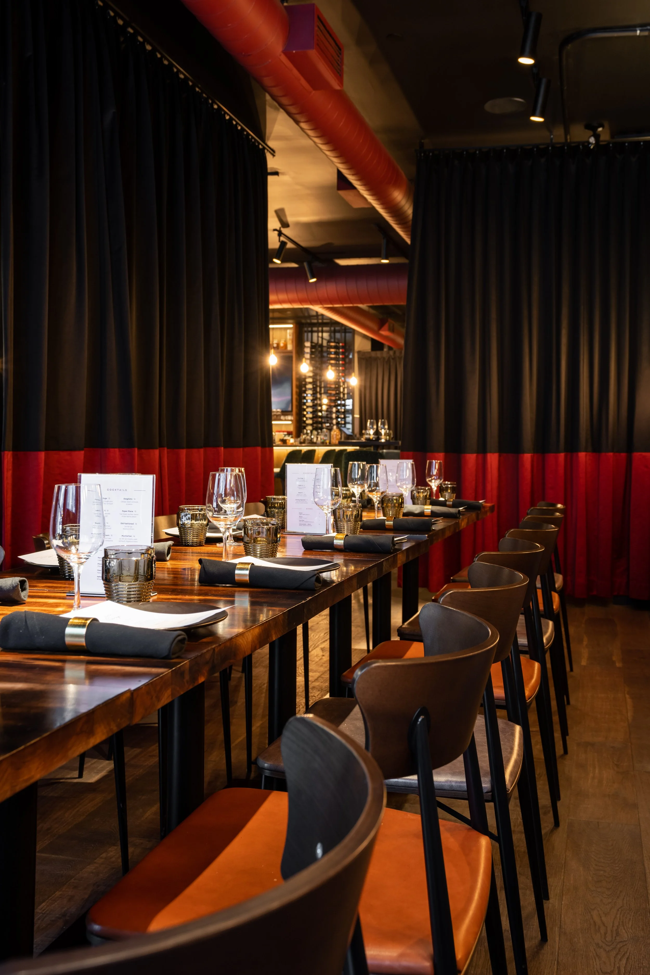 a long table set with group menus ready and waiting for corporate group, party or event to sit down for a private dinner.