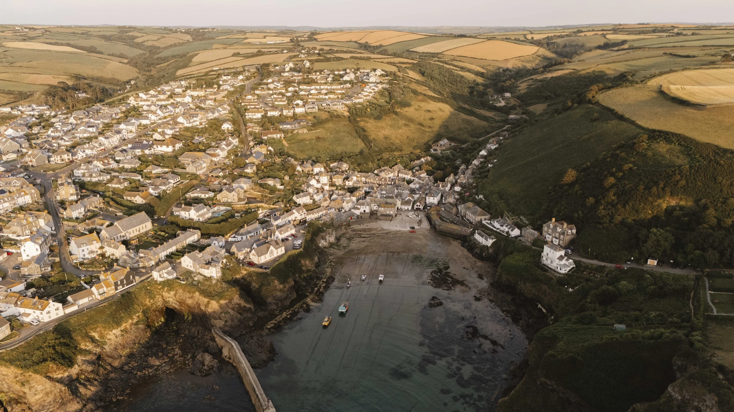 Aerial view of Port Isaac, North Cornwall, with its harbour and rolling green hills