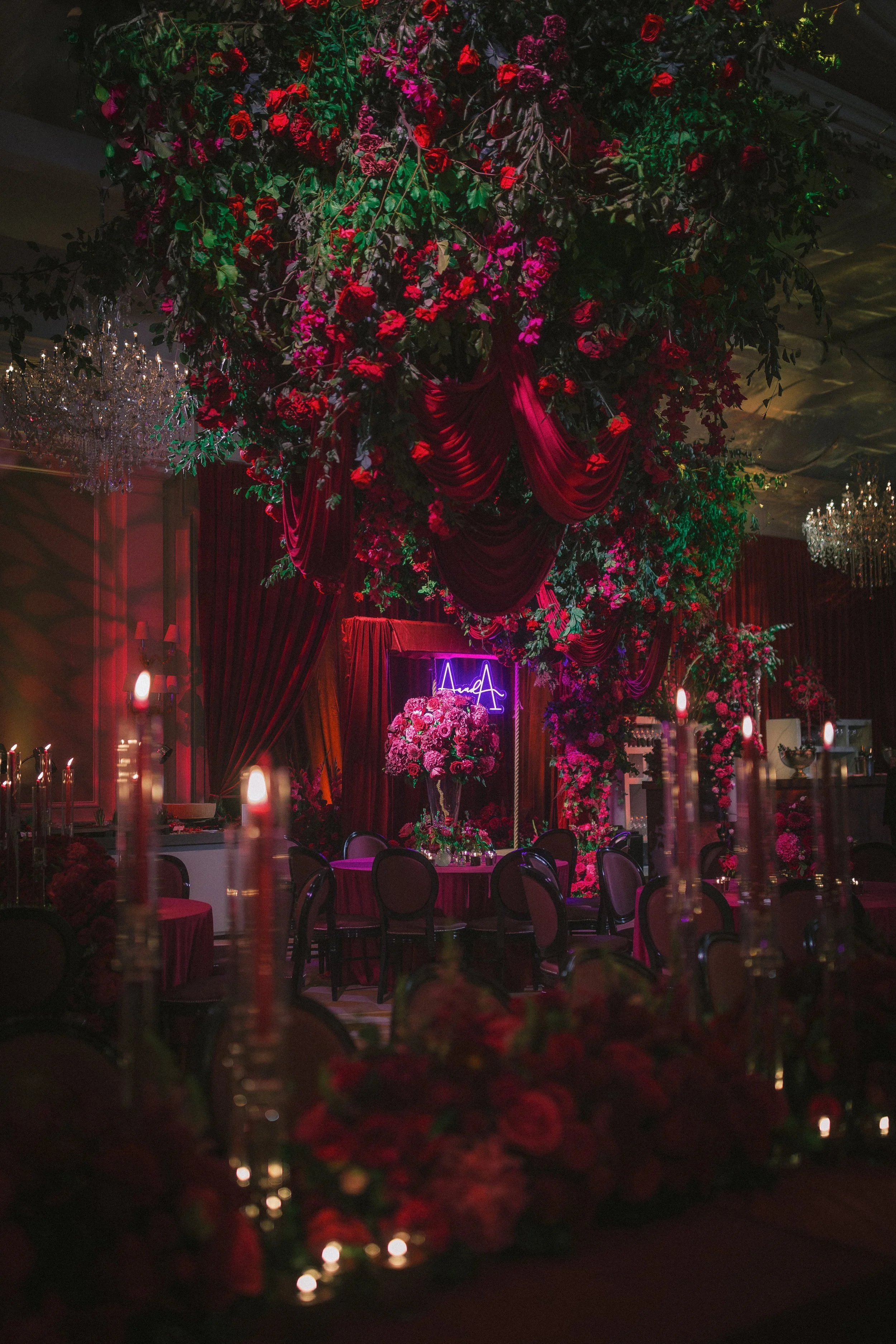 Breathtaking ceiling floral installation by Amie Bone Flowers at Raffles London, featuring lush red blooms and greenery for a luxury floral statement.