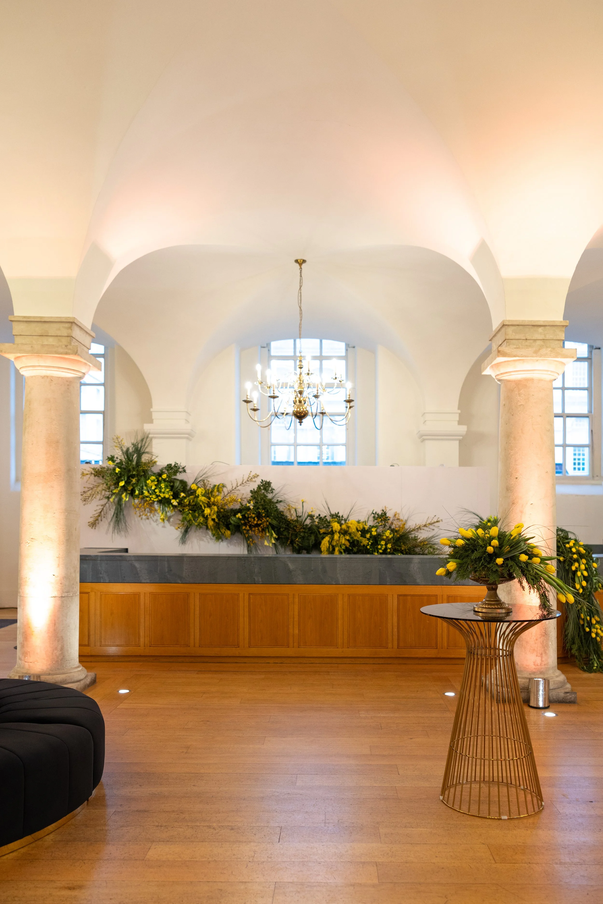 Wide view of cascading bar florals and greenery in the Queen Mary Undercroft at the Old Royal Naval College showcase