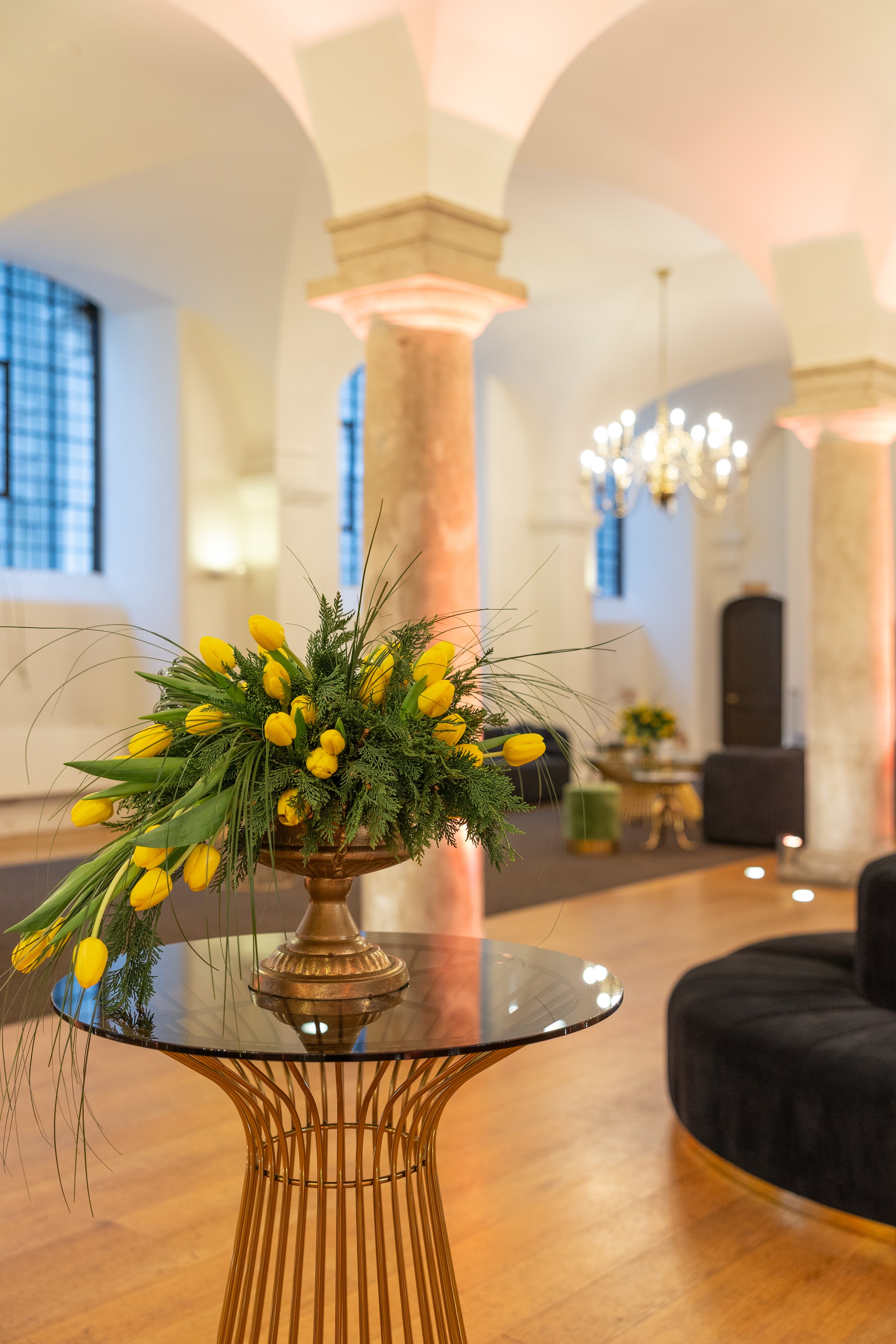 Spring floral arrangements styled on poseur tables during welcome drinks at the Old Royal Naval College