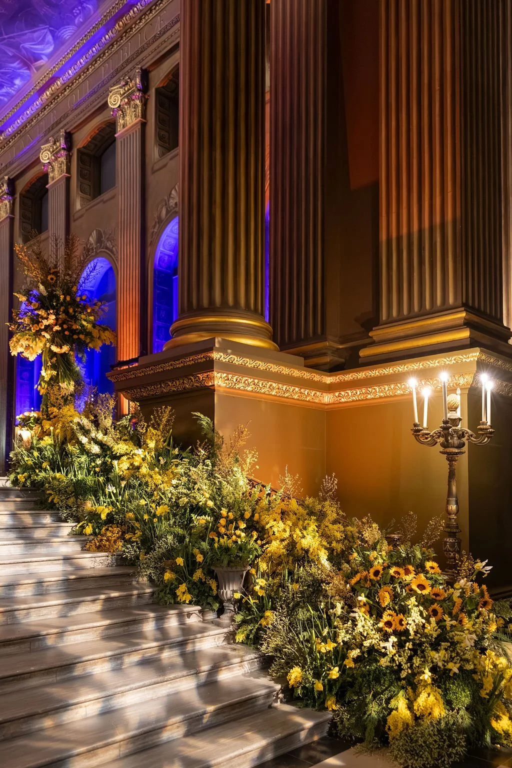 Floral installations softening the columns and architecture of the Painted Hall at the Old Royal Naval College