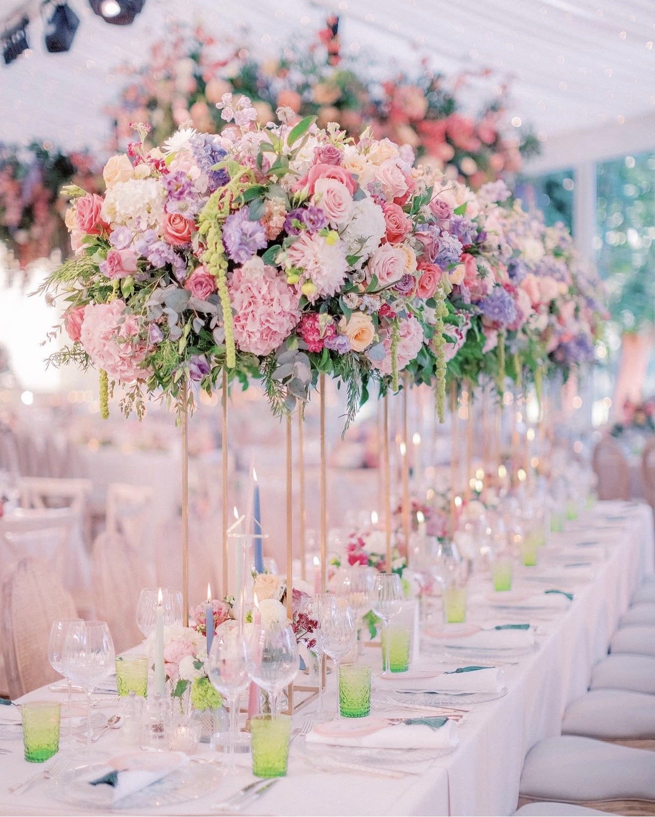 Luxury floral tablescape on private land featuring elevated pastel centrepieces, soft candlelight, and immersive event florals designed to create atmosphere and emotional impact.