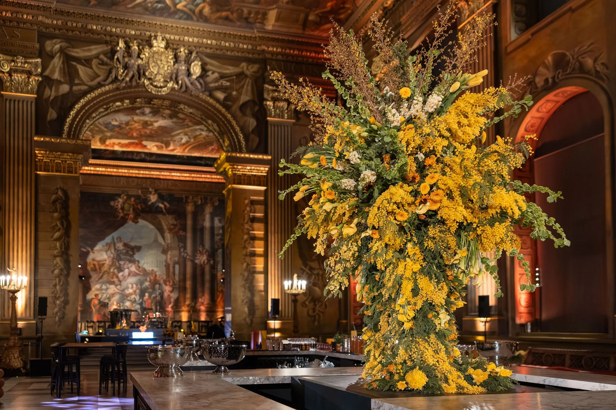 Painted Hall bar dressed with large-scale spring floral installations at the Old Royal Naval College