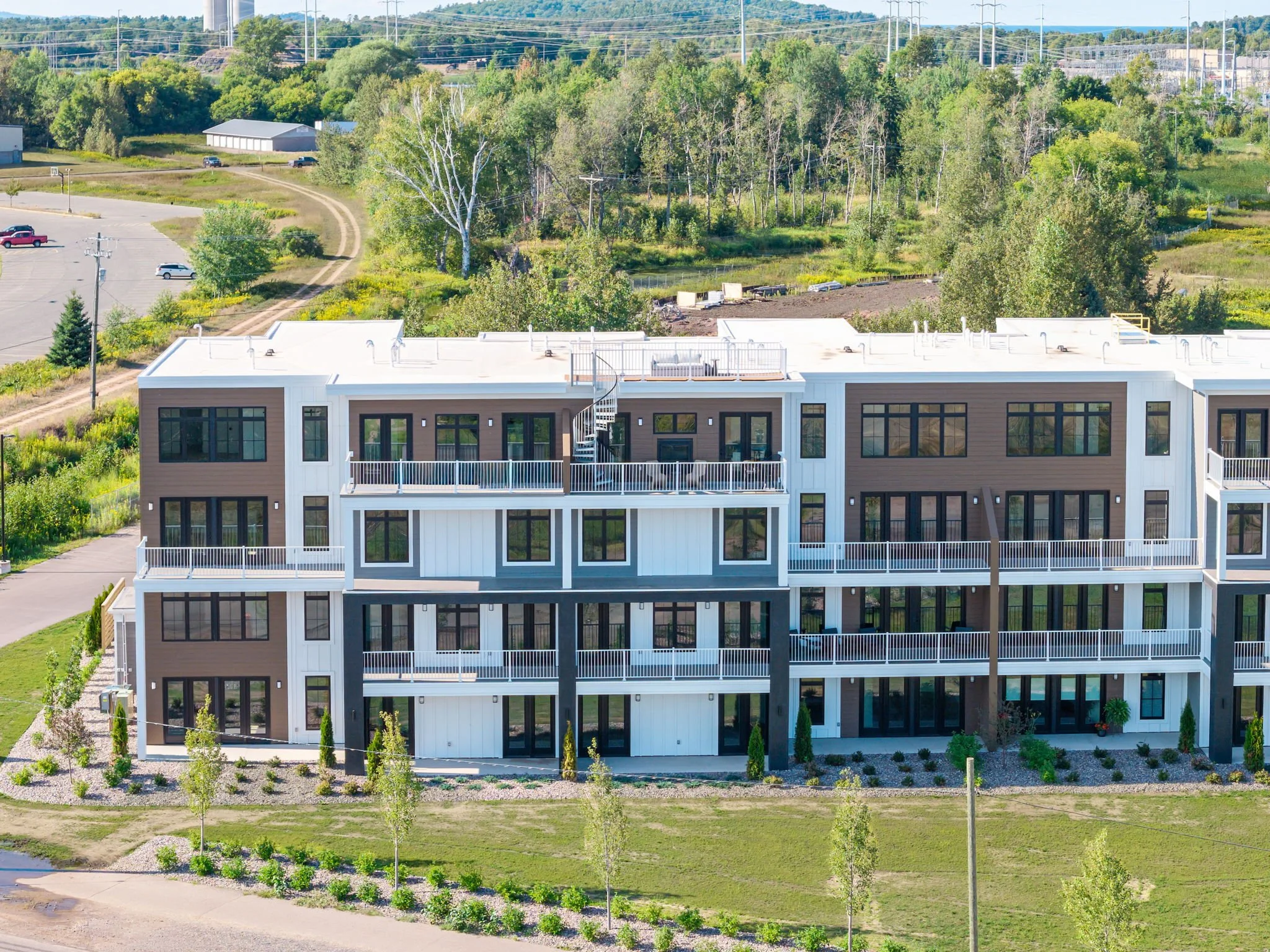 A modern multi-story residential building with balconies, The Residences at North Harbor on Lake Superior in Marquette Michigan. 