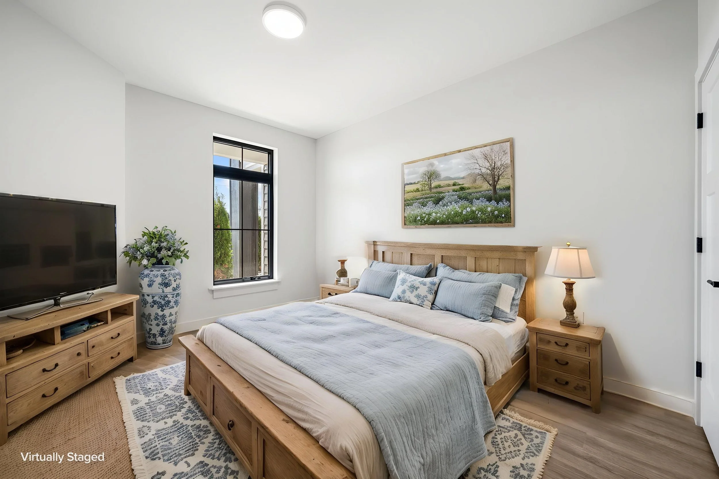 Bedroom with wooden furniture, bed with blue and white bedding. The Residences at North Harbor on Lake Superior in Marquette Michigan.