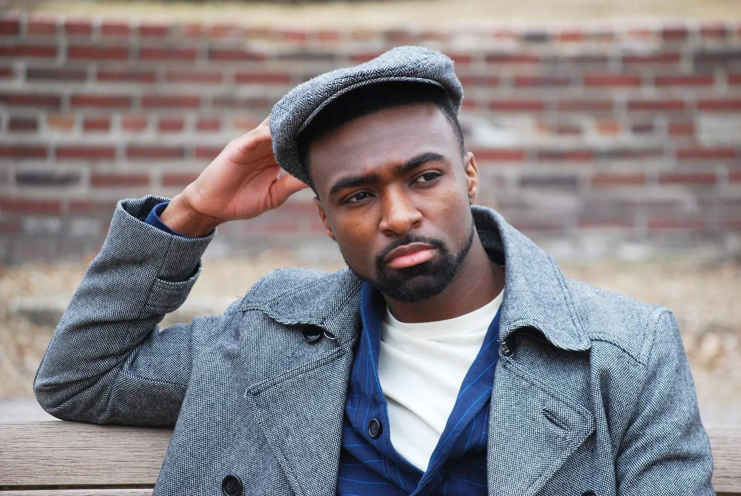 Creative portrait of a man in a cap and blue waistcoat
