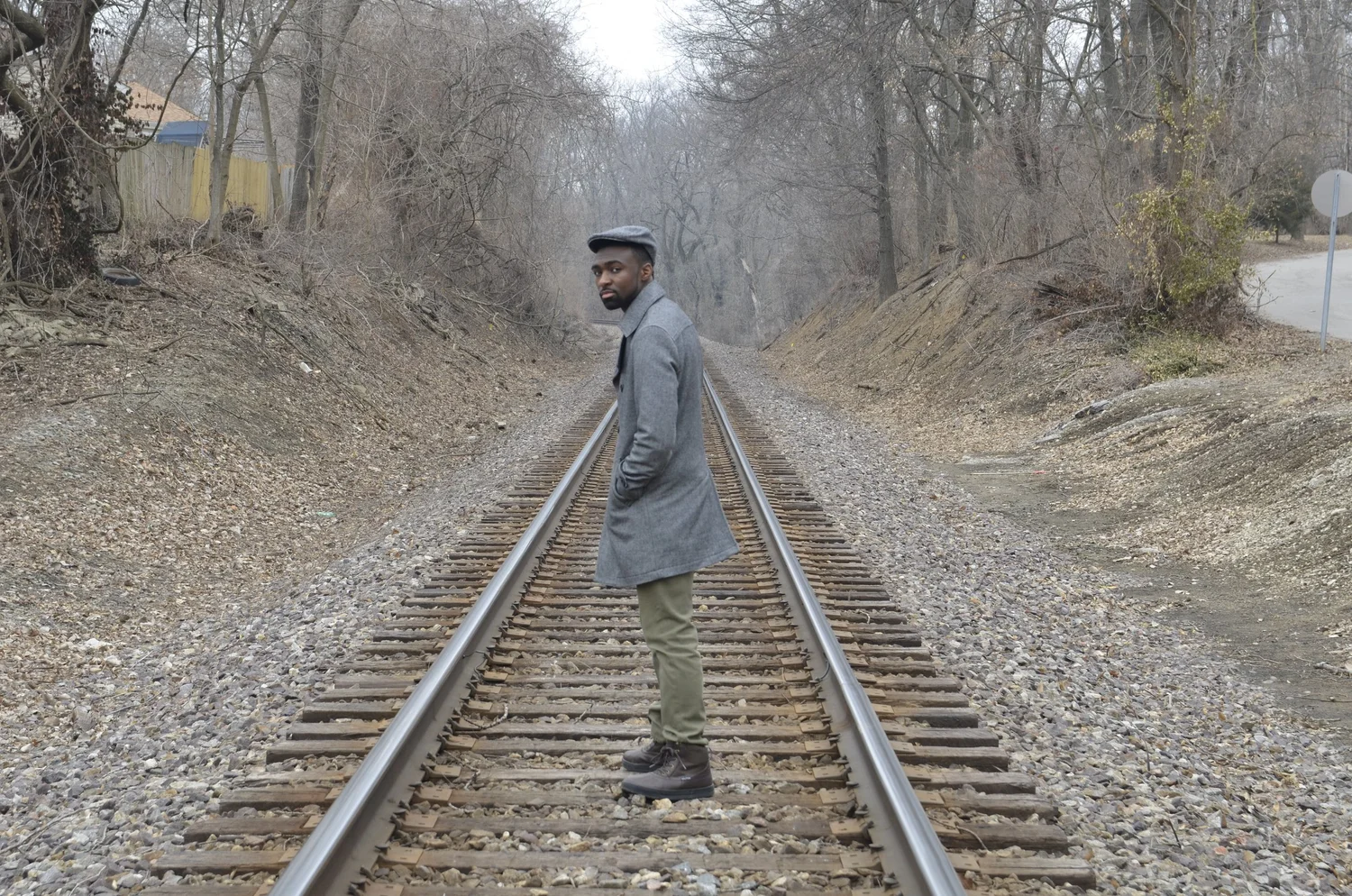 Environmental portrait of a man on a wooded railway