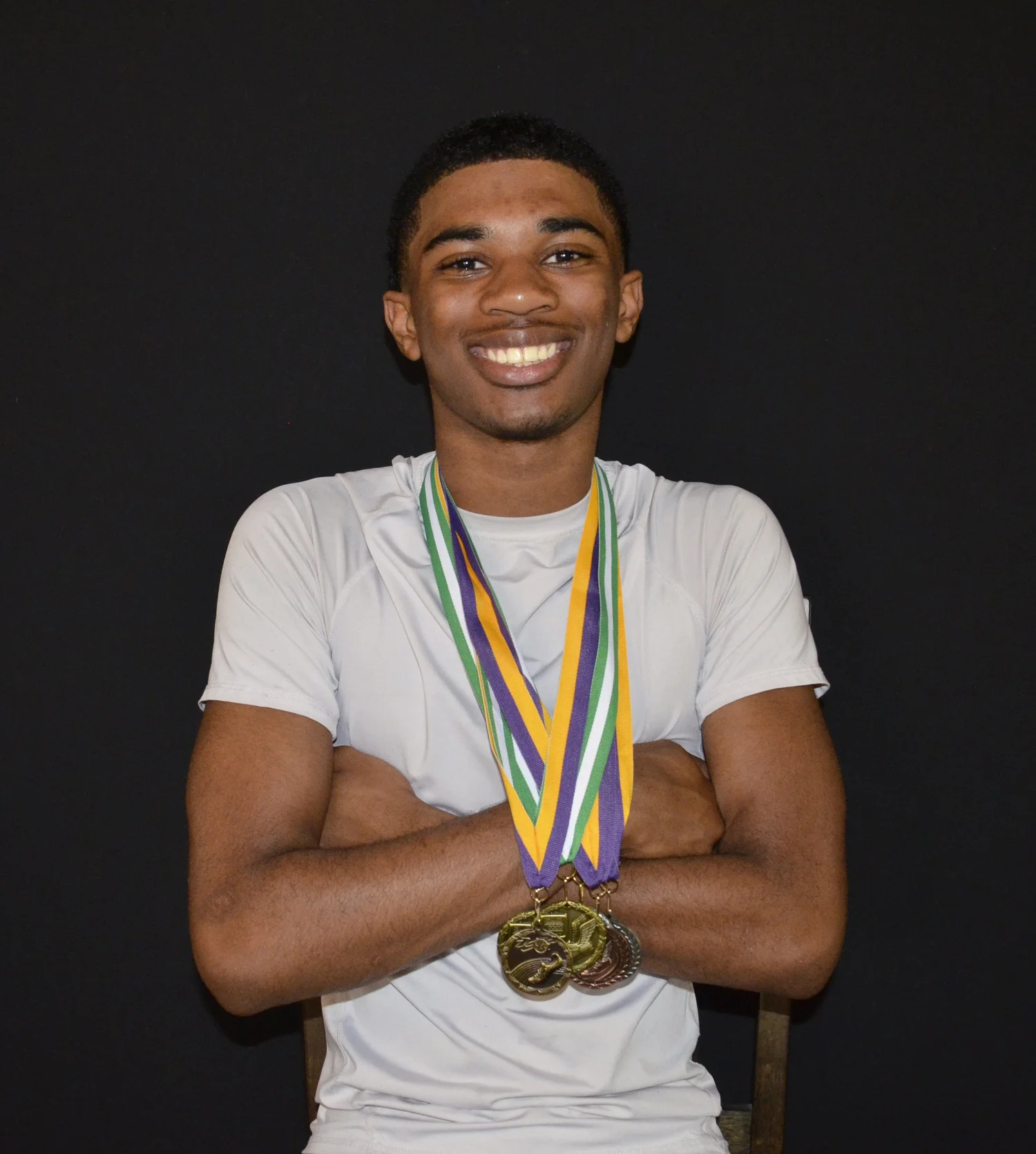 An athlete celebrating his achievements with medals