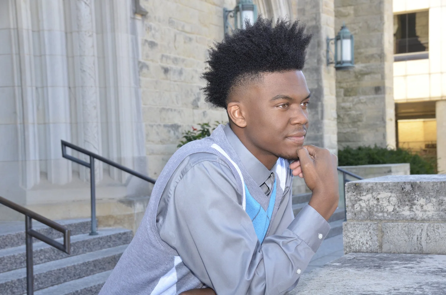 A young man seated outdoors for a personal branding portrait