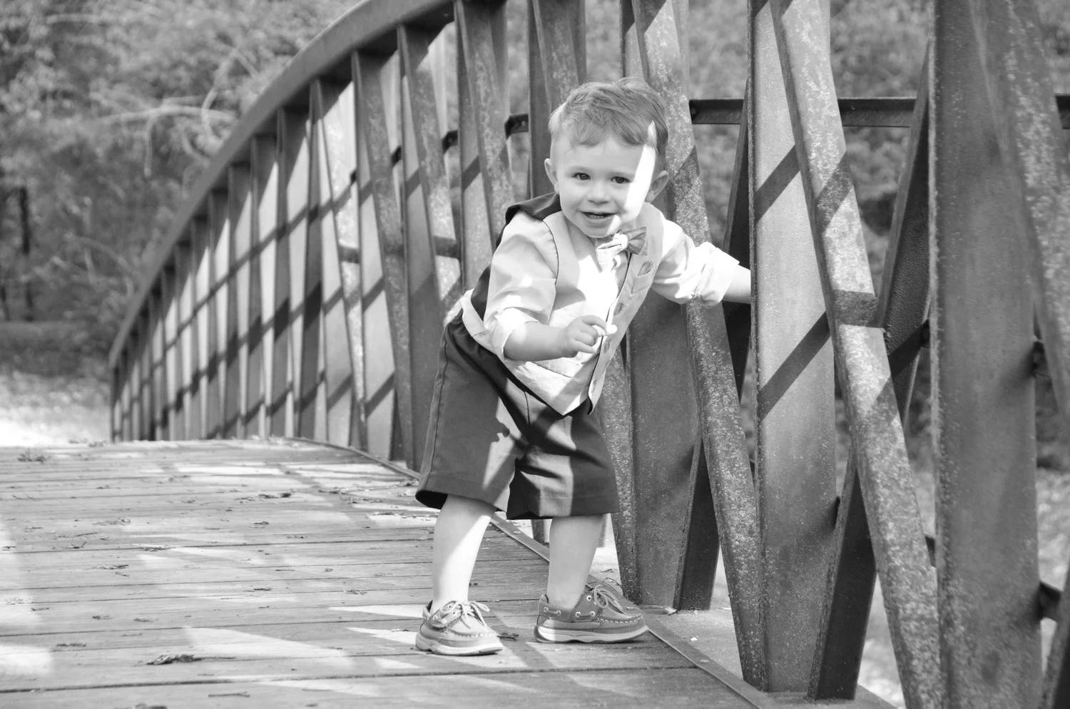 A child smiling on an outdoor bridge