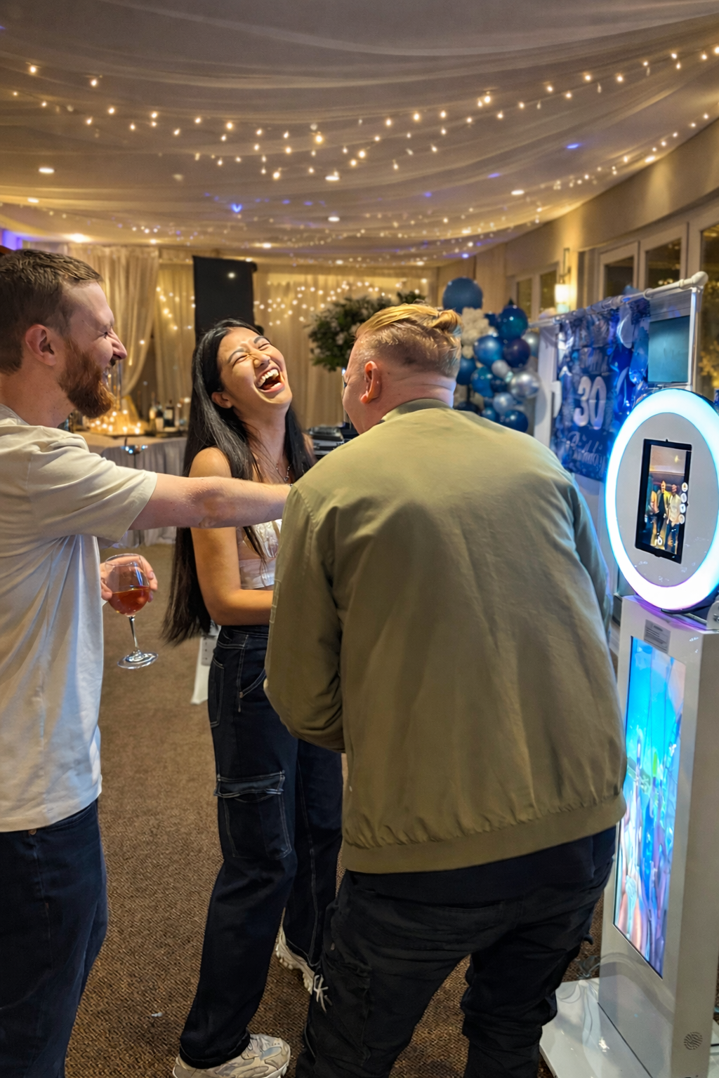 Guests enjoying a Photo Booth at a birthday party