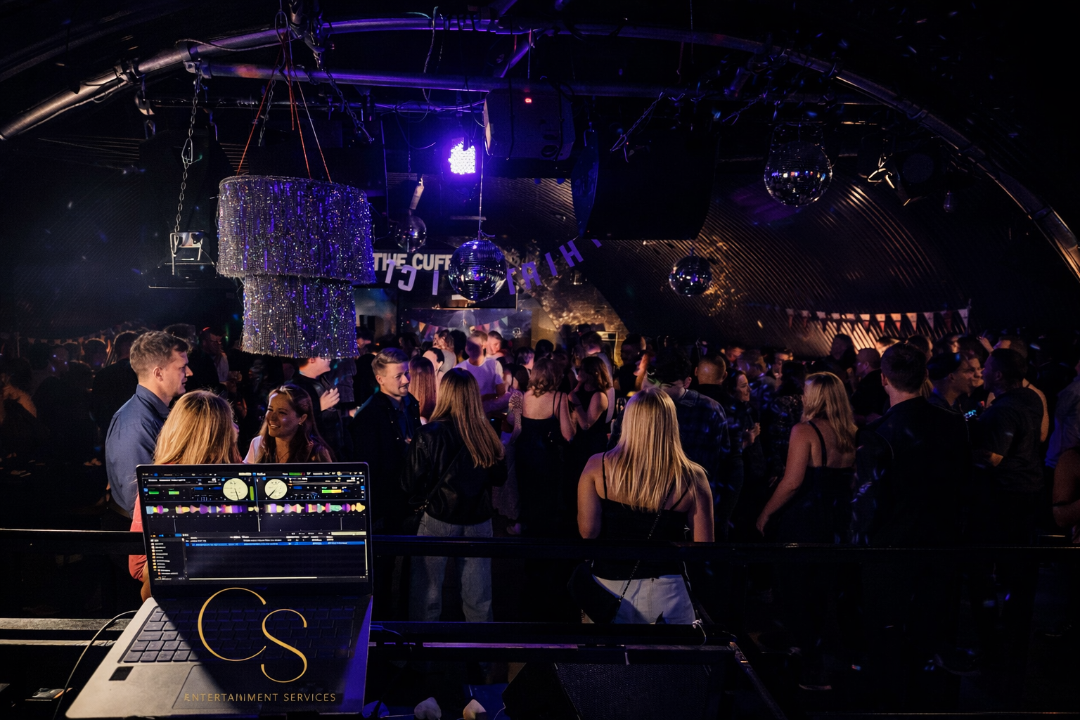 Guests on the dance floor enjoying music by the party DJ 