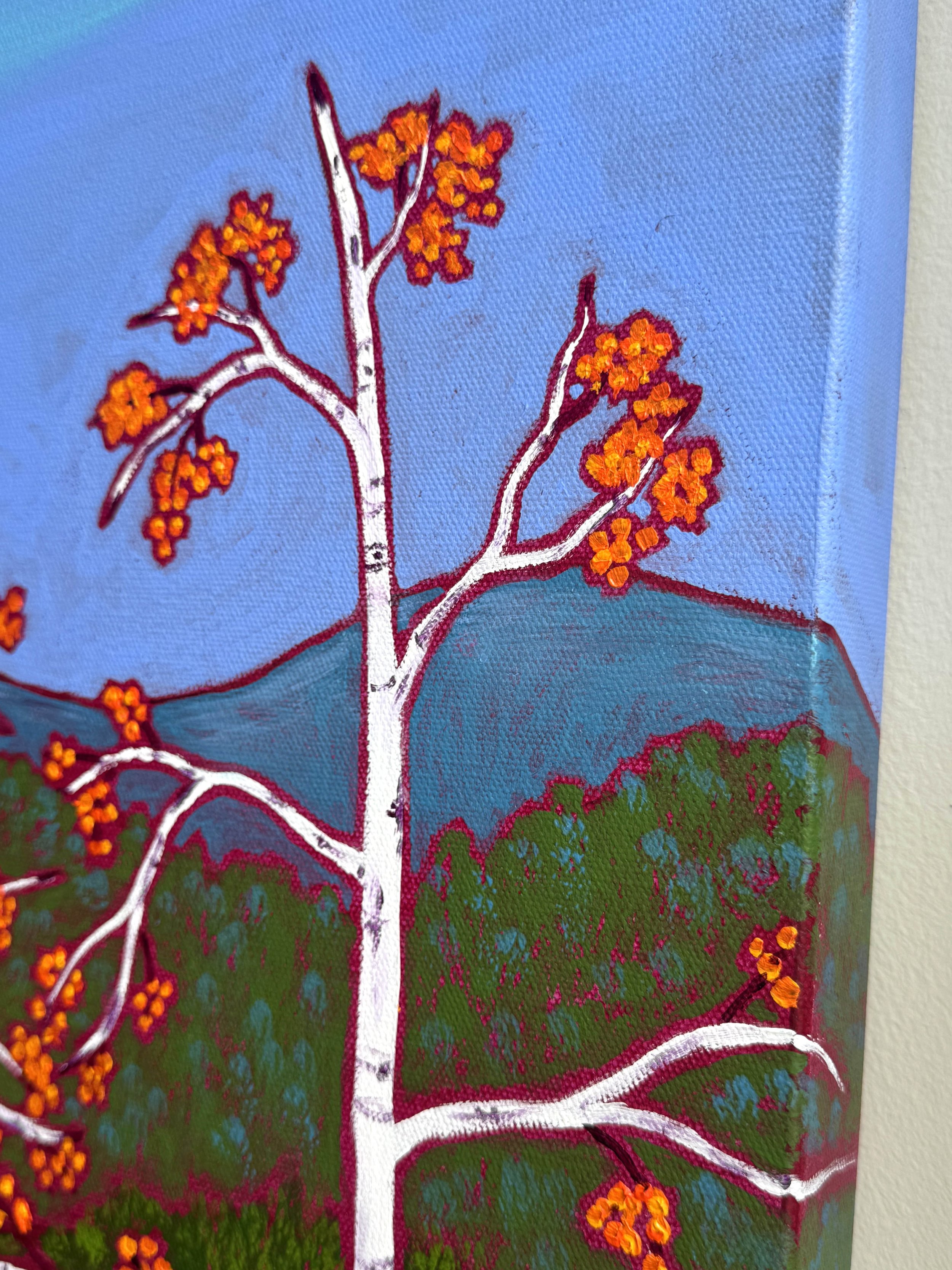 birches at peak foliage i new england with brilliant orange foliage popping against a bright blue sky