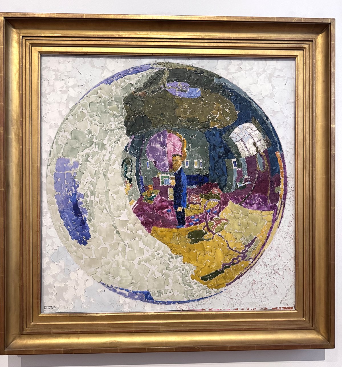 A painting of an artist in his studio, as seen through a glass-like orb that distorts the images. Bold brush strokes and colors give the painting intense energy.