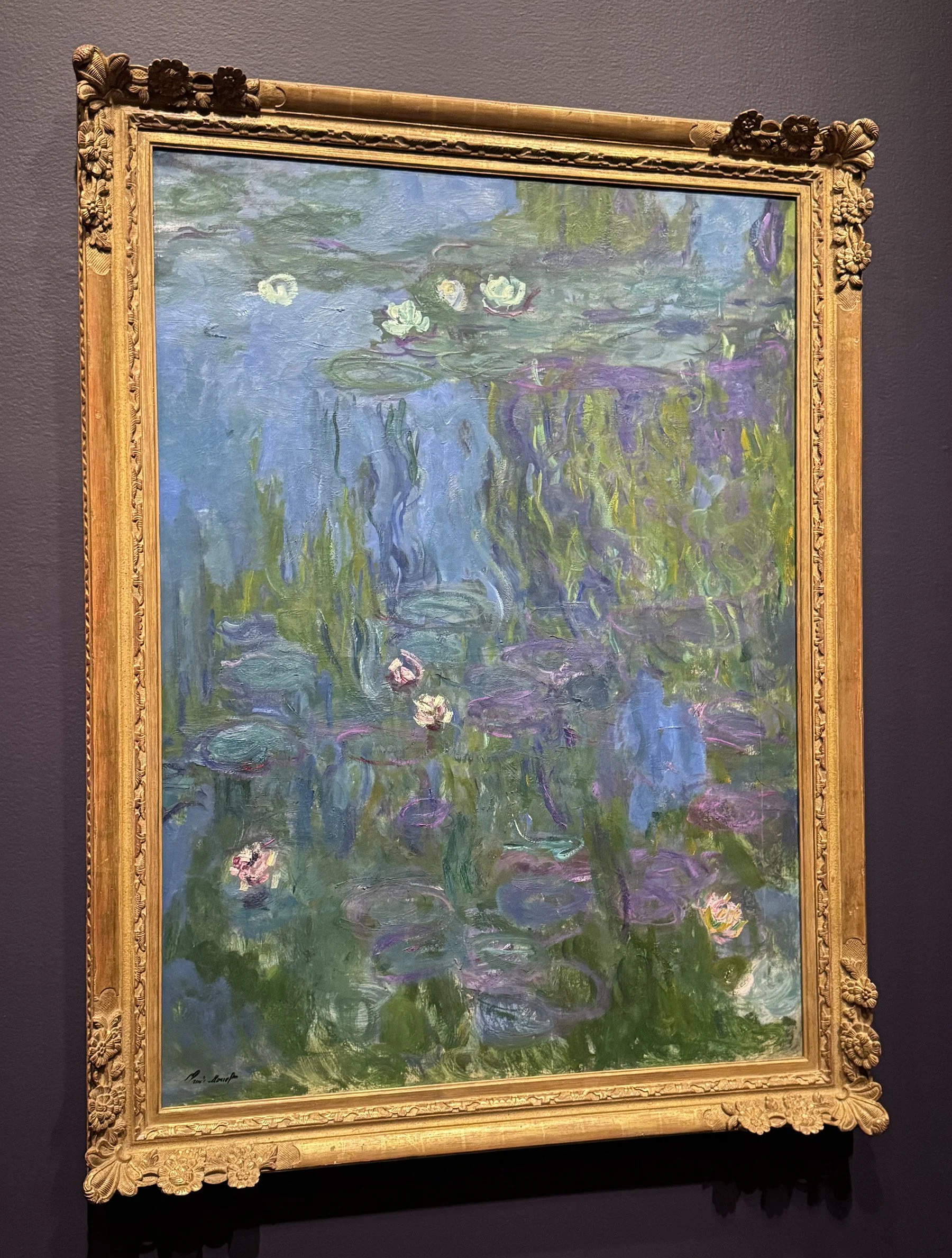 The brushwork on the lilies, water, and willow reflections in this Monet water lily painting are so loosely painted that the painting borders on total abstraction.
