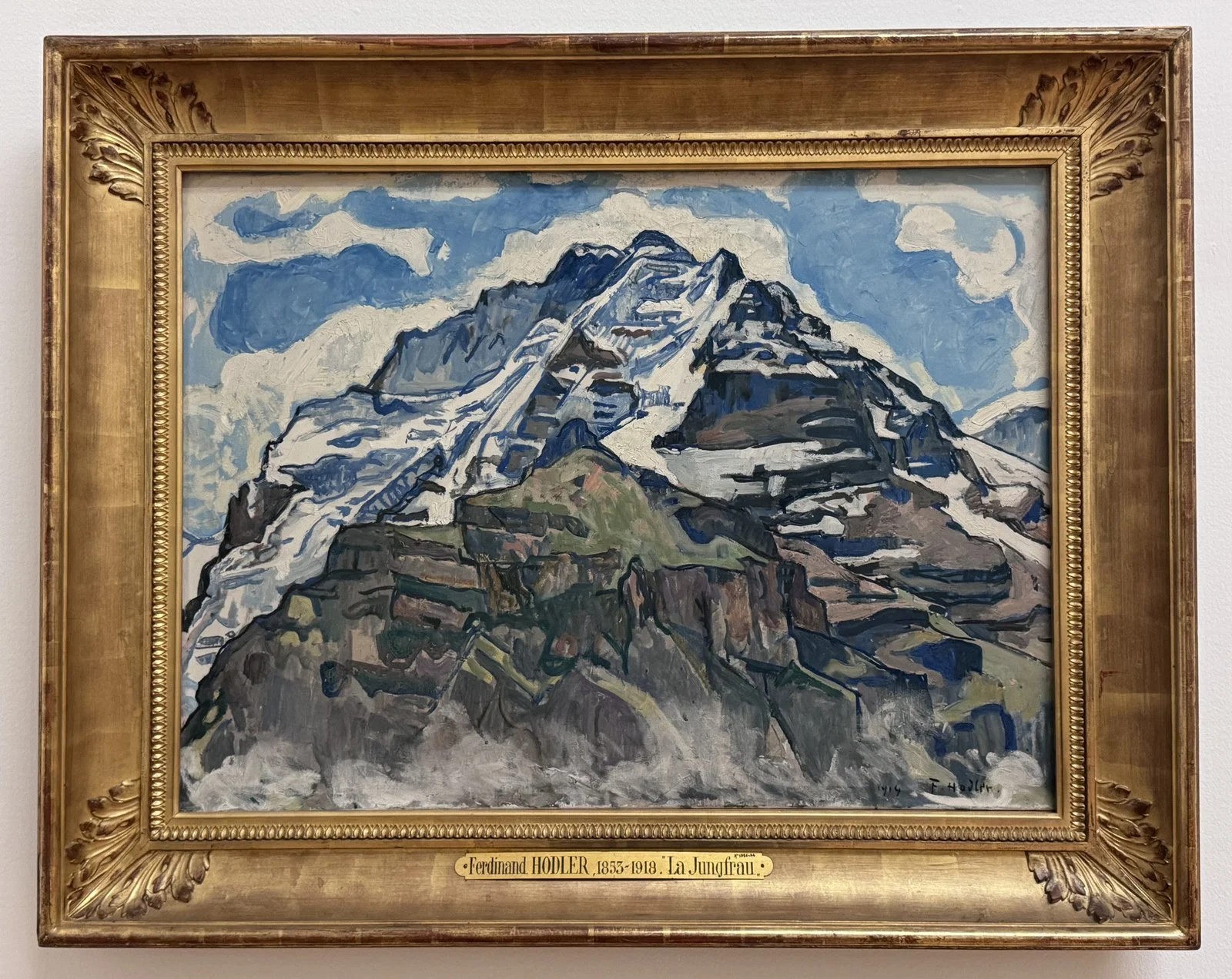 Painting of the snow-capped peak of Jungfrau. The massive mountain dominates the picture plane, with only a little space left for blue sky.