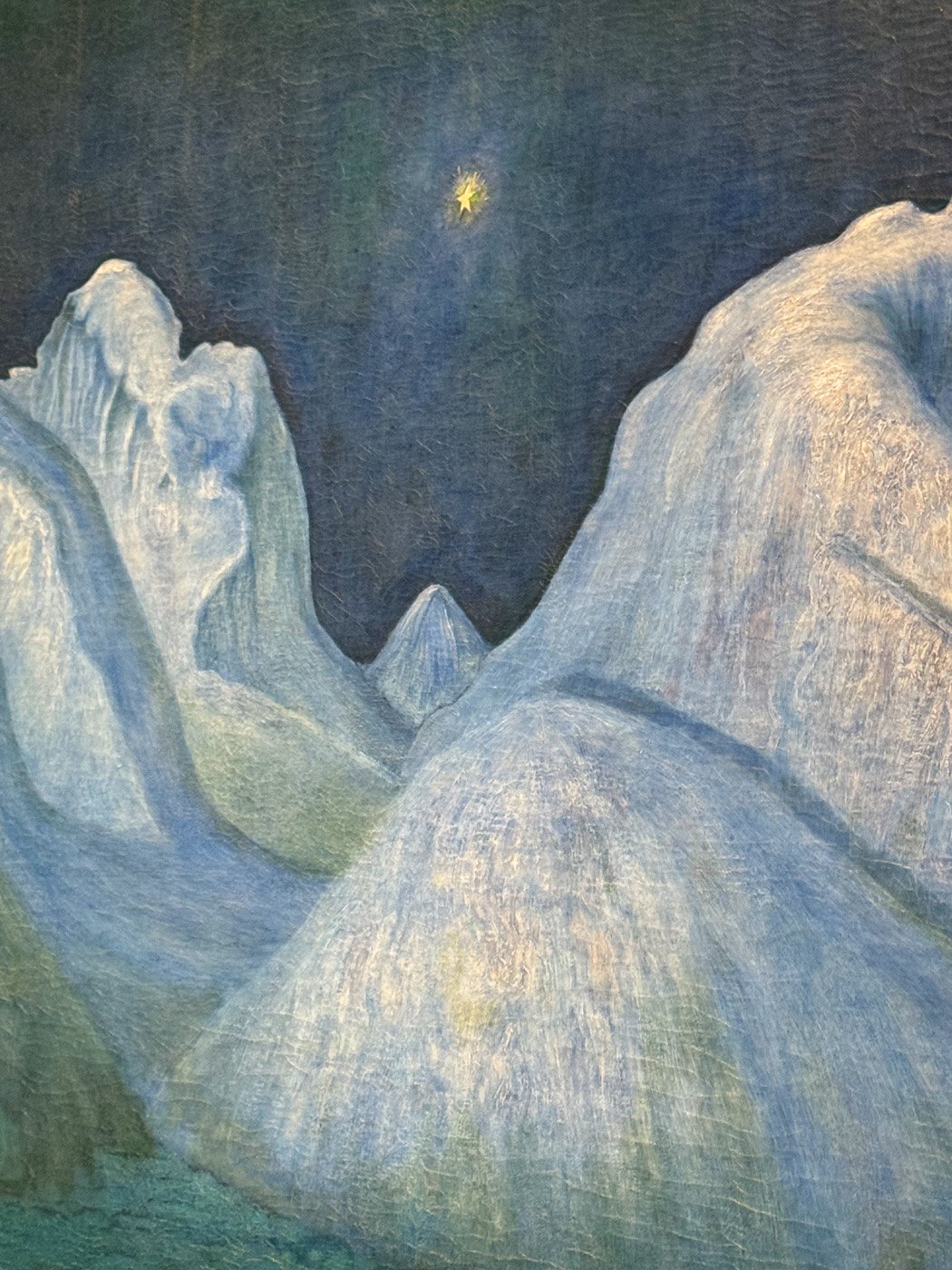 Detail of mountain peaks and shining star against the Blue Night light of Norway.