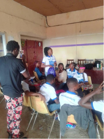 SoAYL student asking the Minister of Education a question at a leadership school run by the students from the African leadership Academy.png