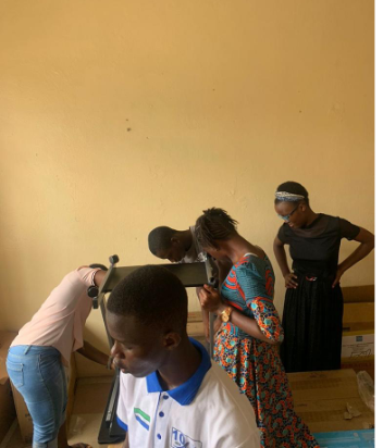 Students getting involved in setting up the computer room.png