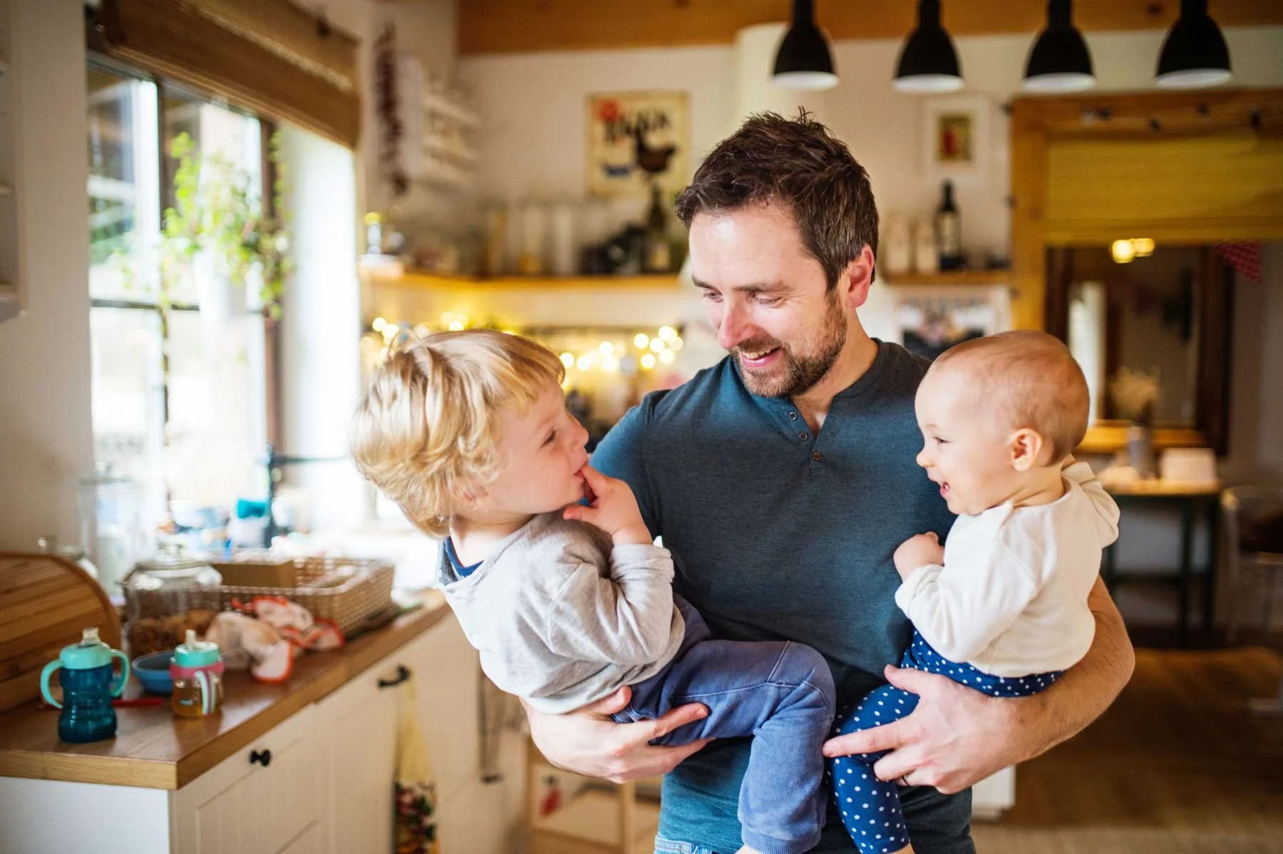 Happy family enjoying comfortable home climate with fan coil system from Expert Heating and Cooling