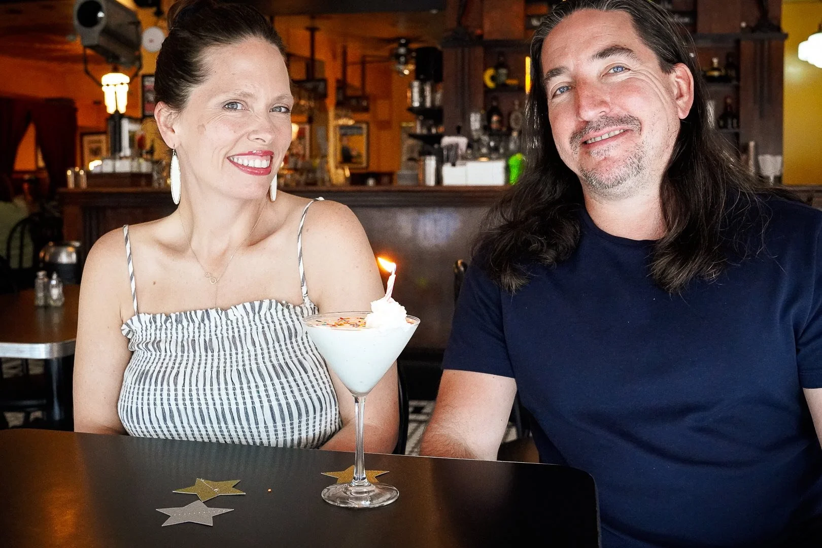 A picture of Danni and Marcus Eickenhorst sitting in the dining room of The FOuntain on Locust with an ice cream martini for their birthday celebration