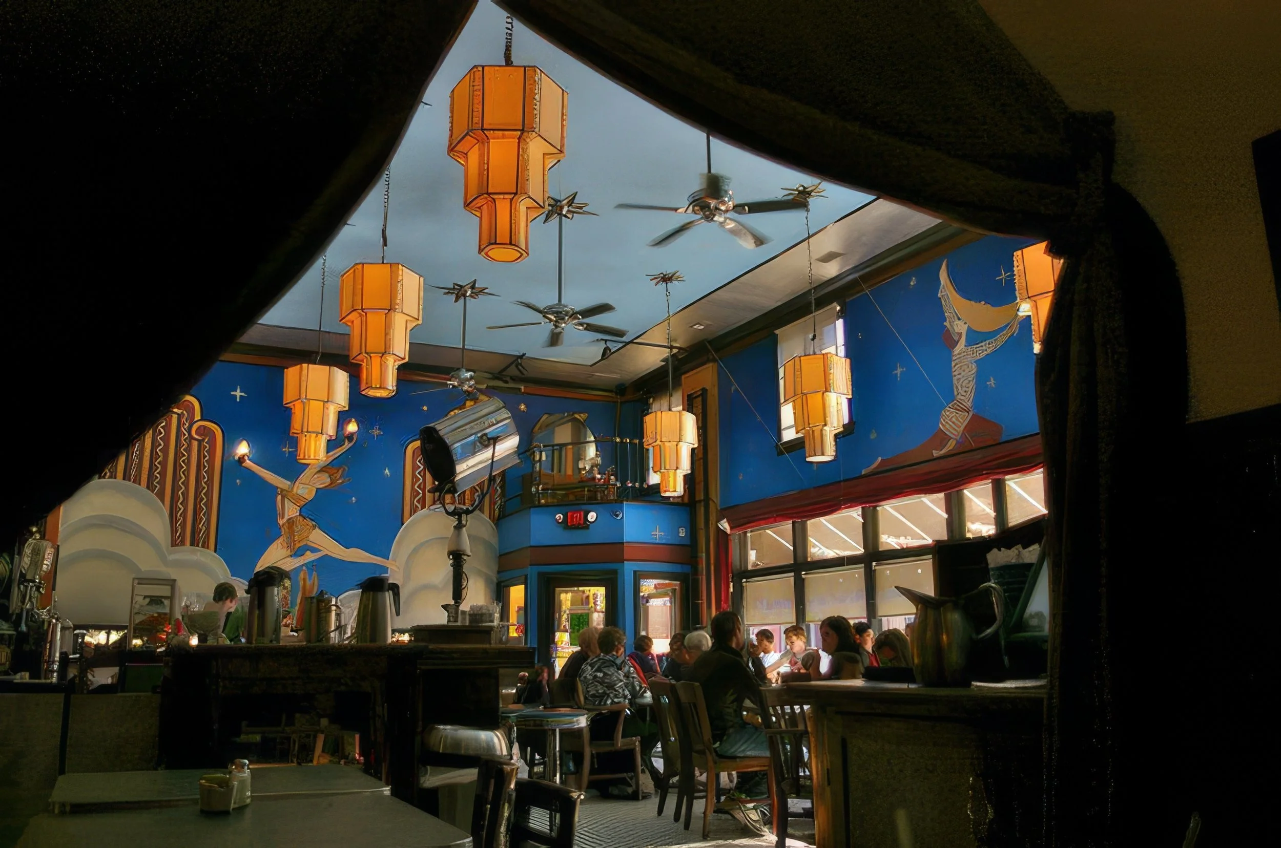 Photo of immersive art restaurant The fountain on Locust taken from inside of a curtained booth looking out to mural covered dining room