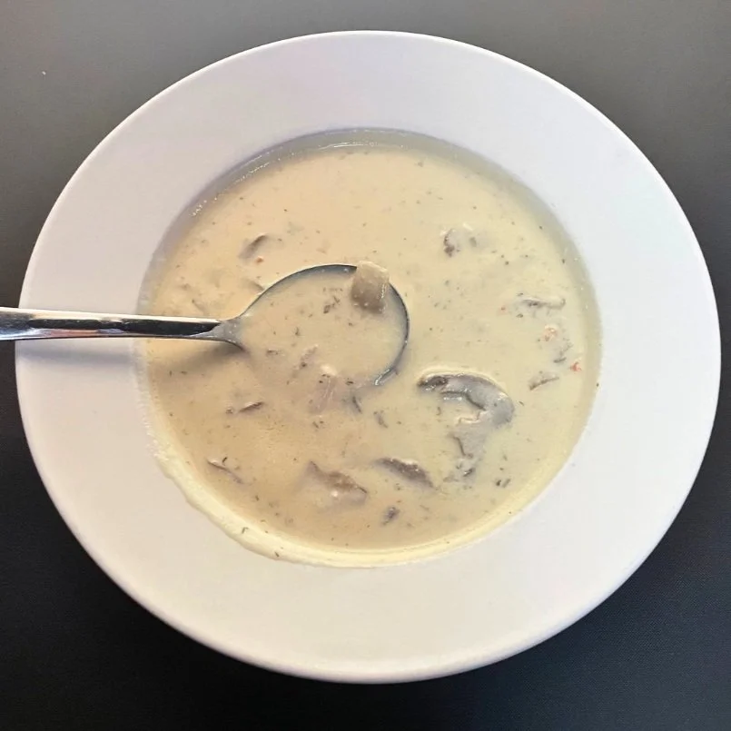 A bowl of Moscow Mushroom Soup with a spoon in it.
