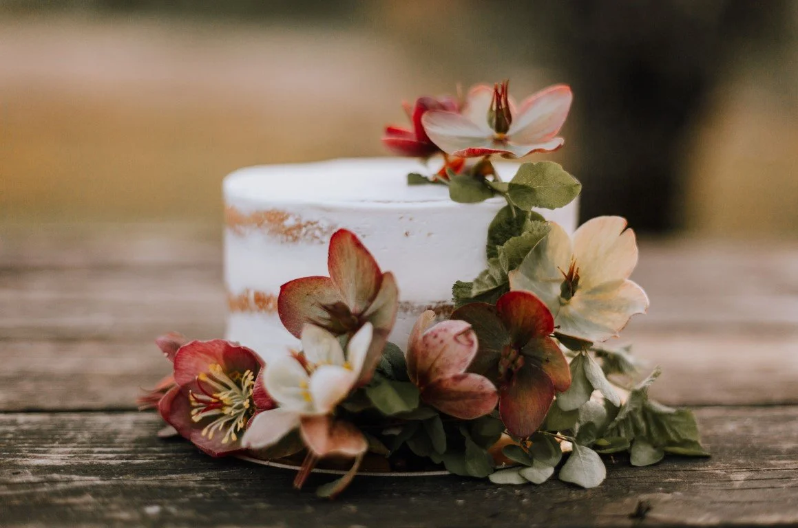 white cake with small pink flowers