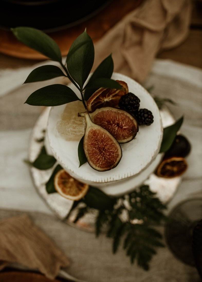 white cake with figs and greenery