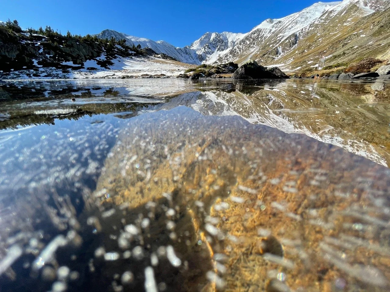 Many frozen lakes with Pic Carlit in the background