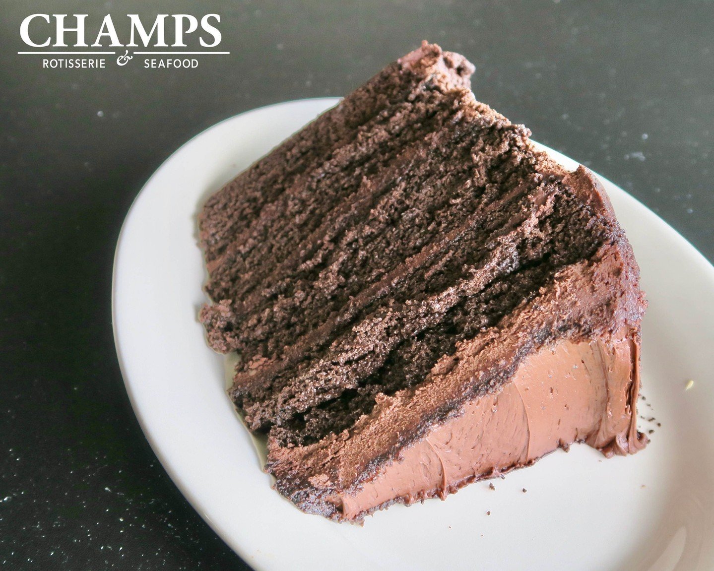 Share a Sweet Moment at Champs with Our Chocolate Cake for Two: Four Layers, Rich Icing, and Chocolate Cookie Crumbs.