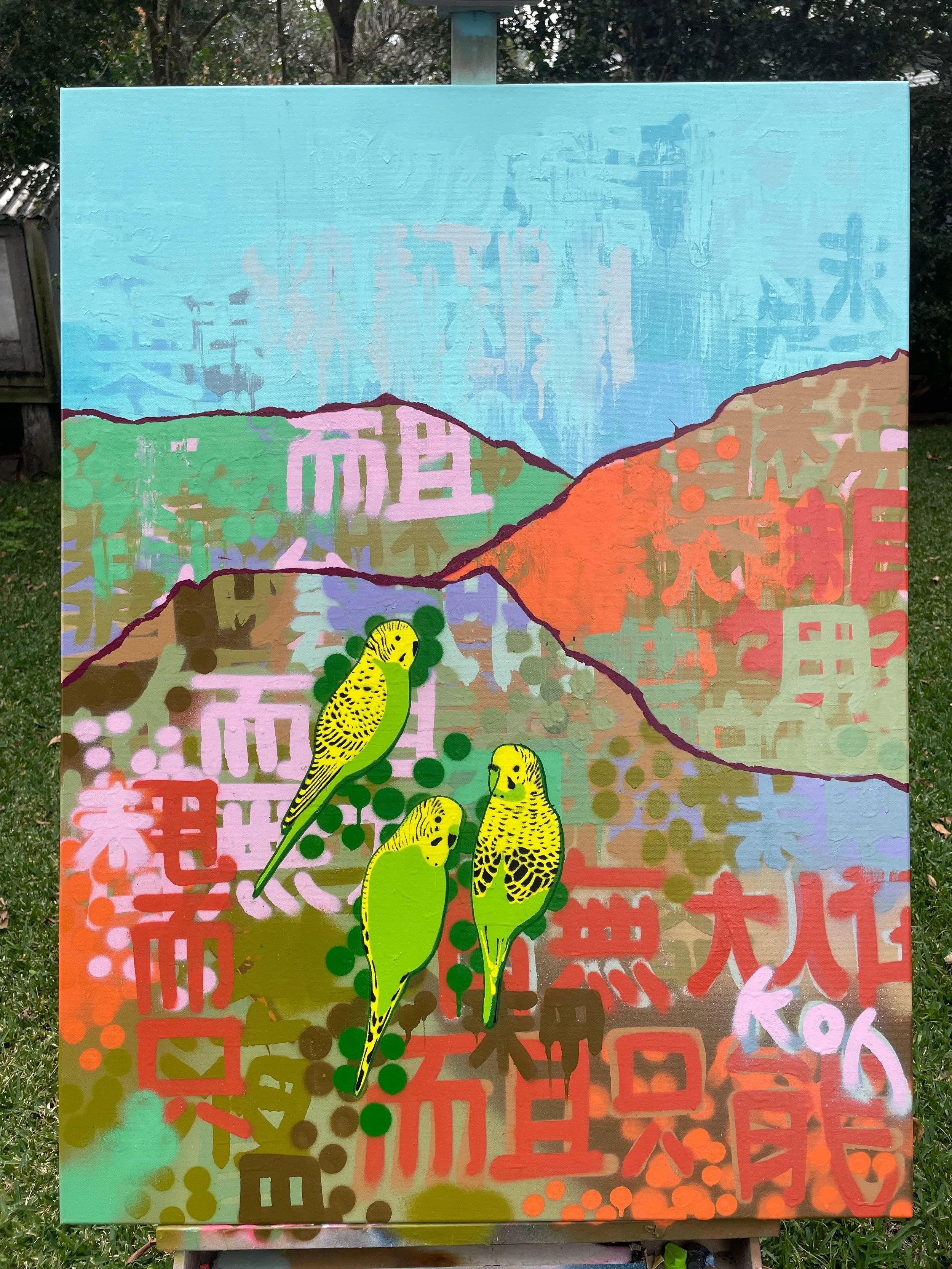 Three Green And Gold Budgies In The Bush.jpg