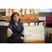 Woman posing in front of an abstract painting in an art gallery.
