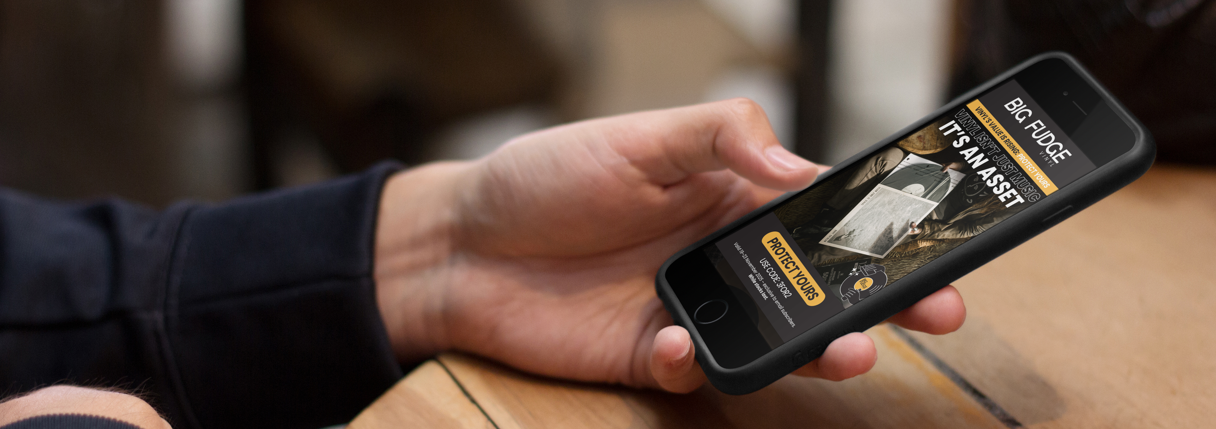 man-at-a-bar-holding-black-iphone-6-mockup-a3940 (1).png