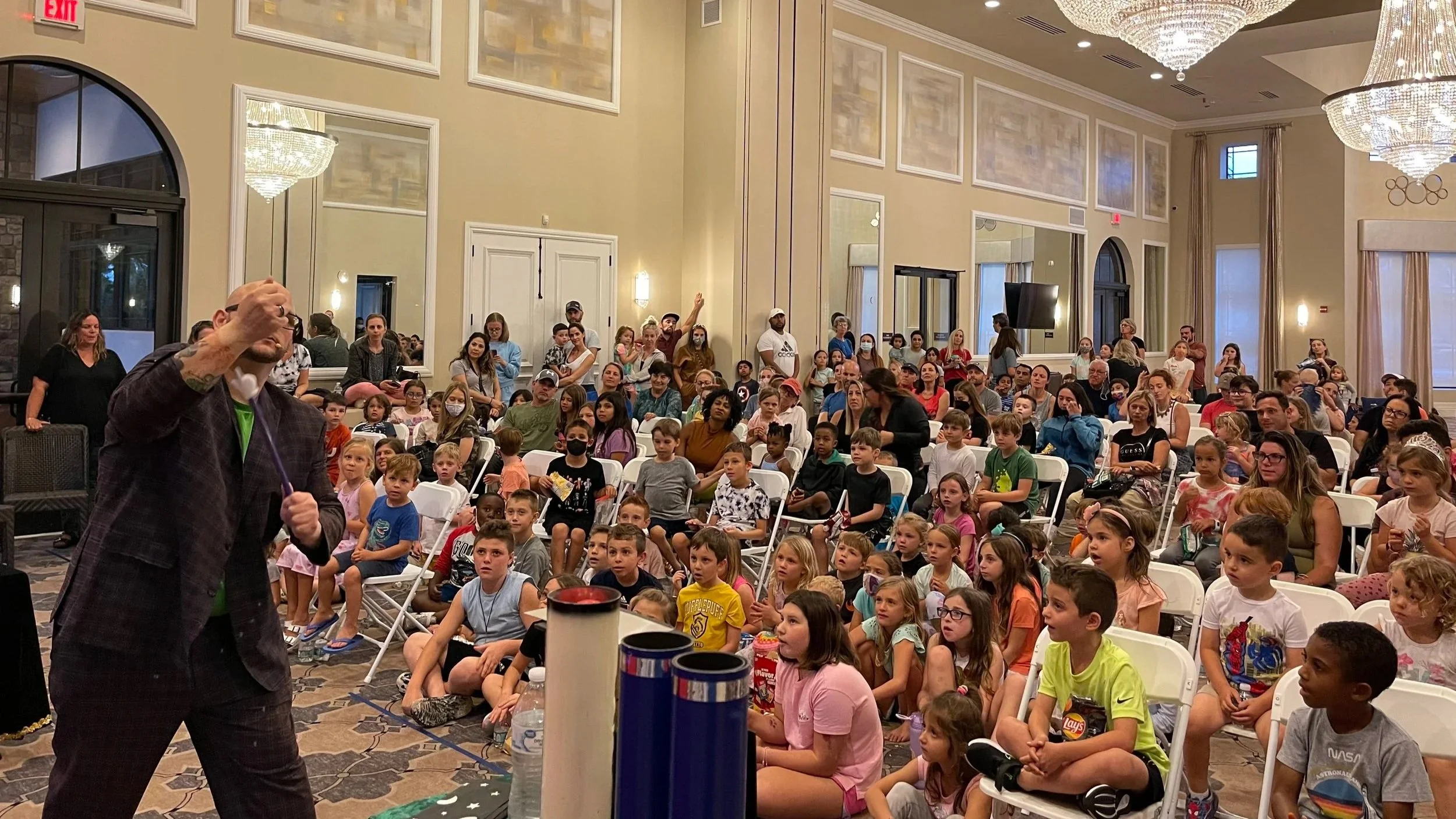 Children laughing and reacting during an interactive family magic show by Big Joey Magic Showy.