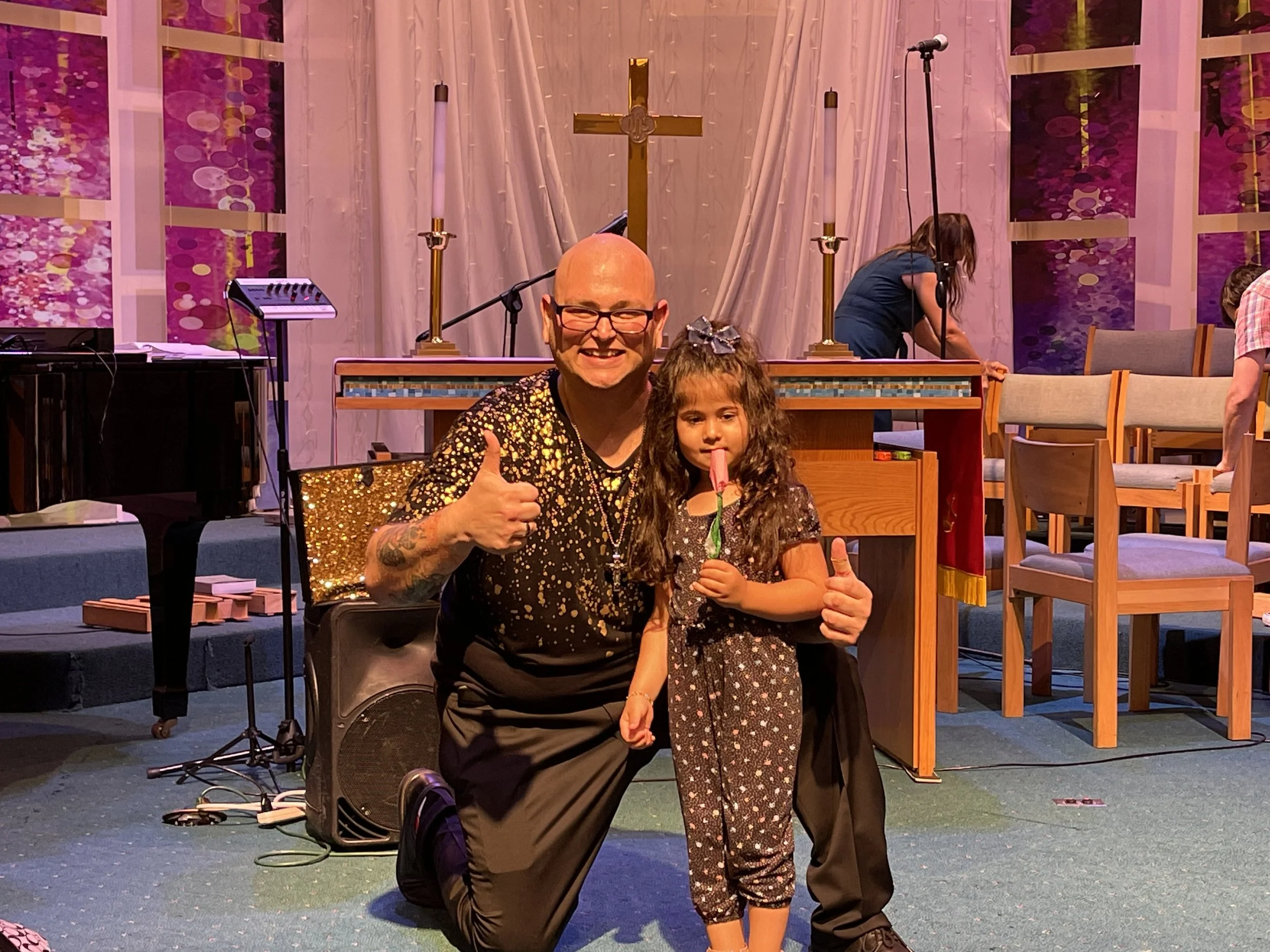 Magician with child on stage performing magic