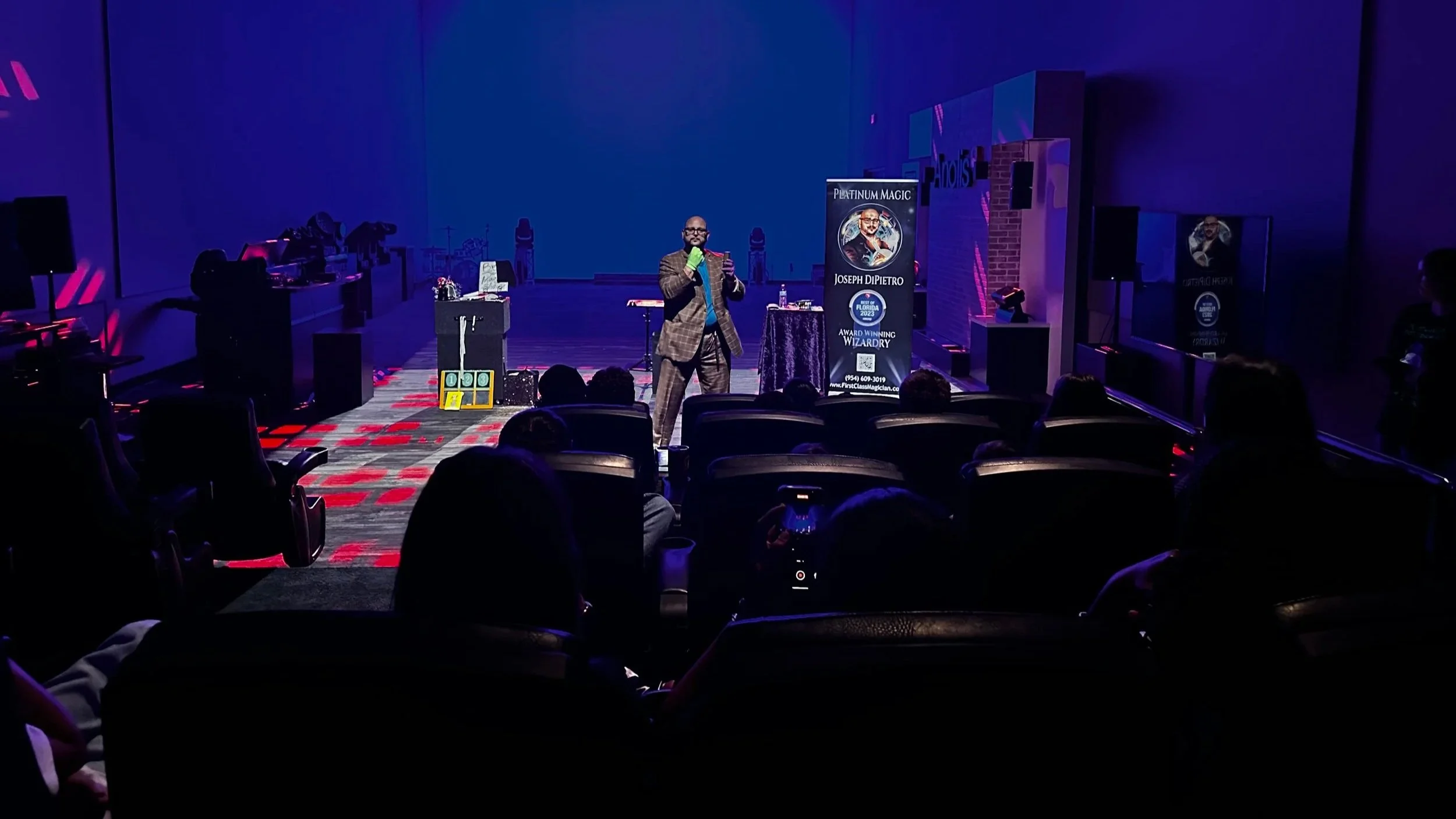 Large group of kids and families enjoying a high-energy interactive magic show.