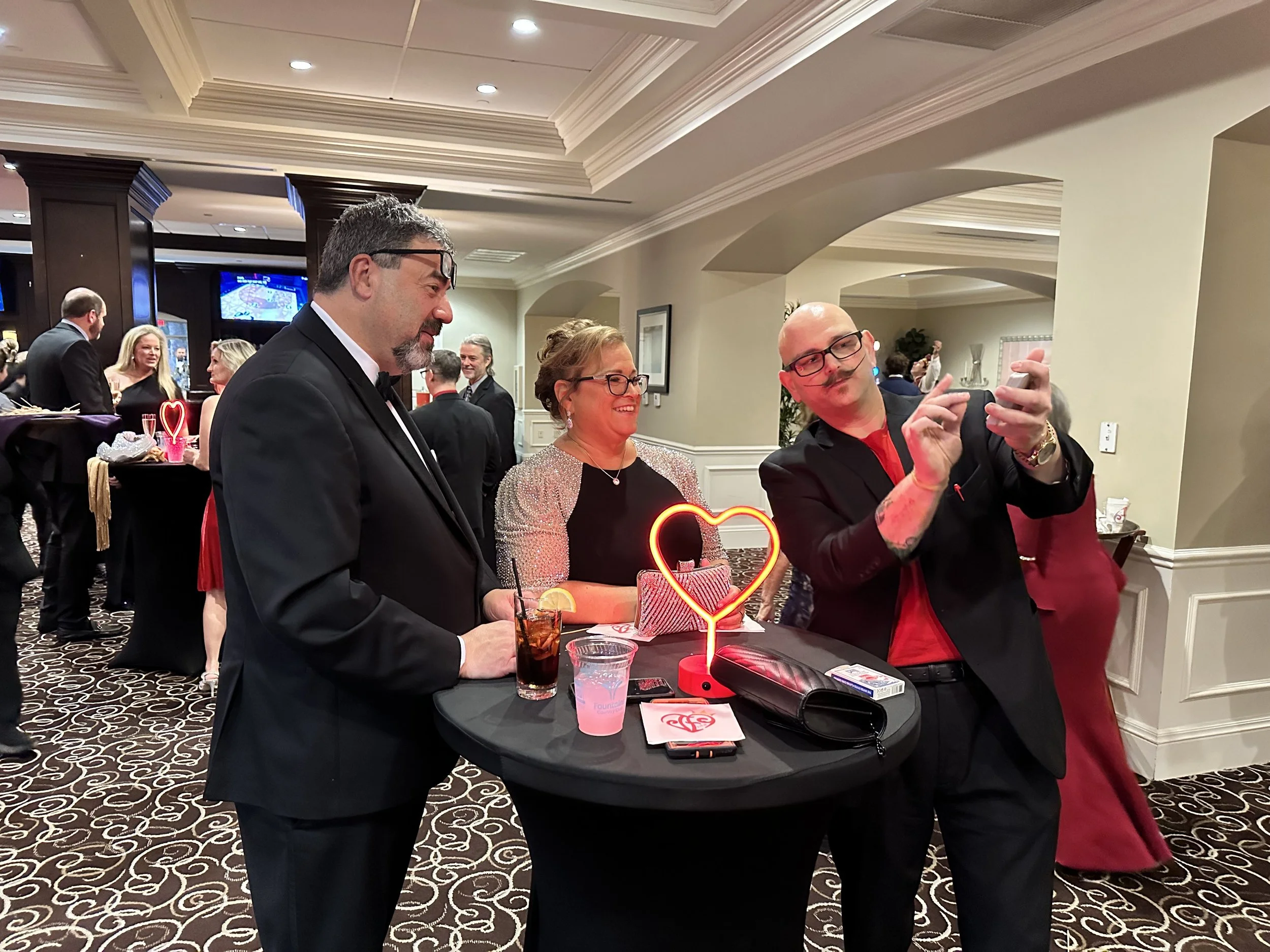 Big Joey Magic Showy performing close-up magic during a cocktail hour for corporate guests.