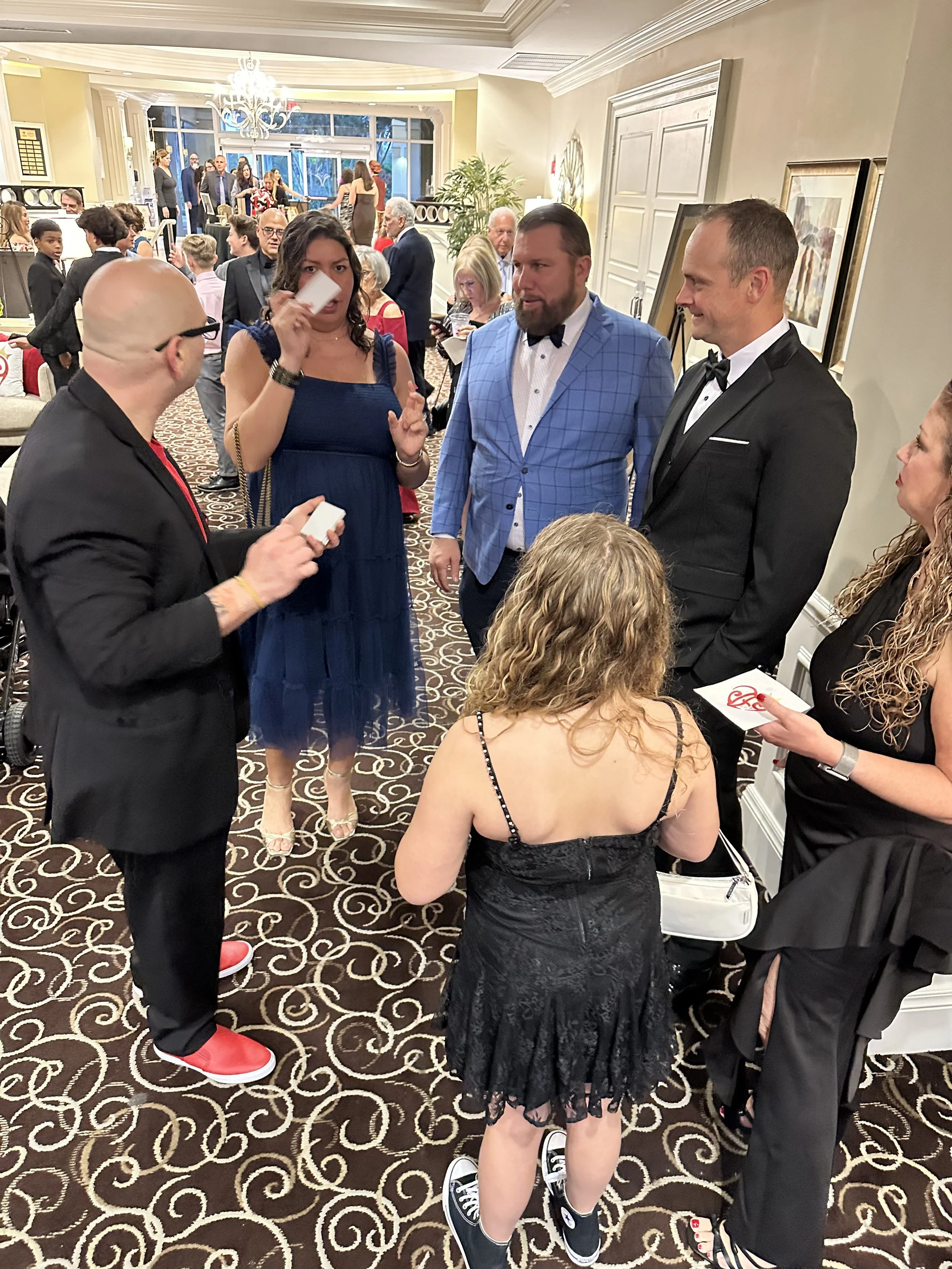 Corporate entertainer Big Joey Magic Showy performing interactive magic for guests at a professional event in Florida.