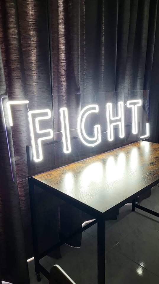 Neon sign with "Fight" written on it
