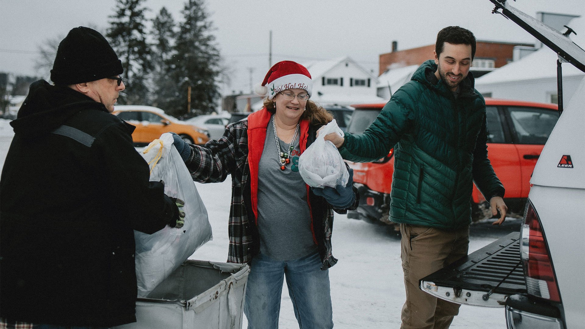 Man and woman accepting donations from a man at St Vinnies in Iron Mountain